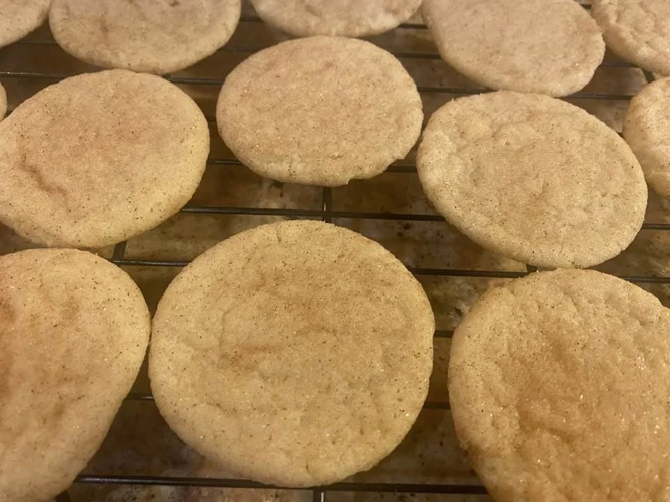 Snickerdoodles made by Wisconsin Cottage Bakery Twelve Moons Baking, cooling on a wire rack.
