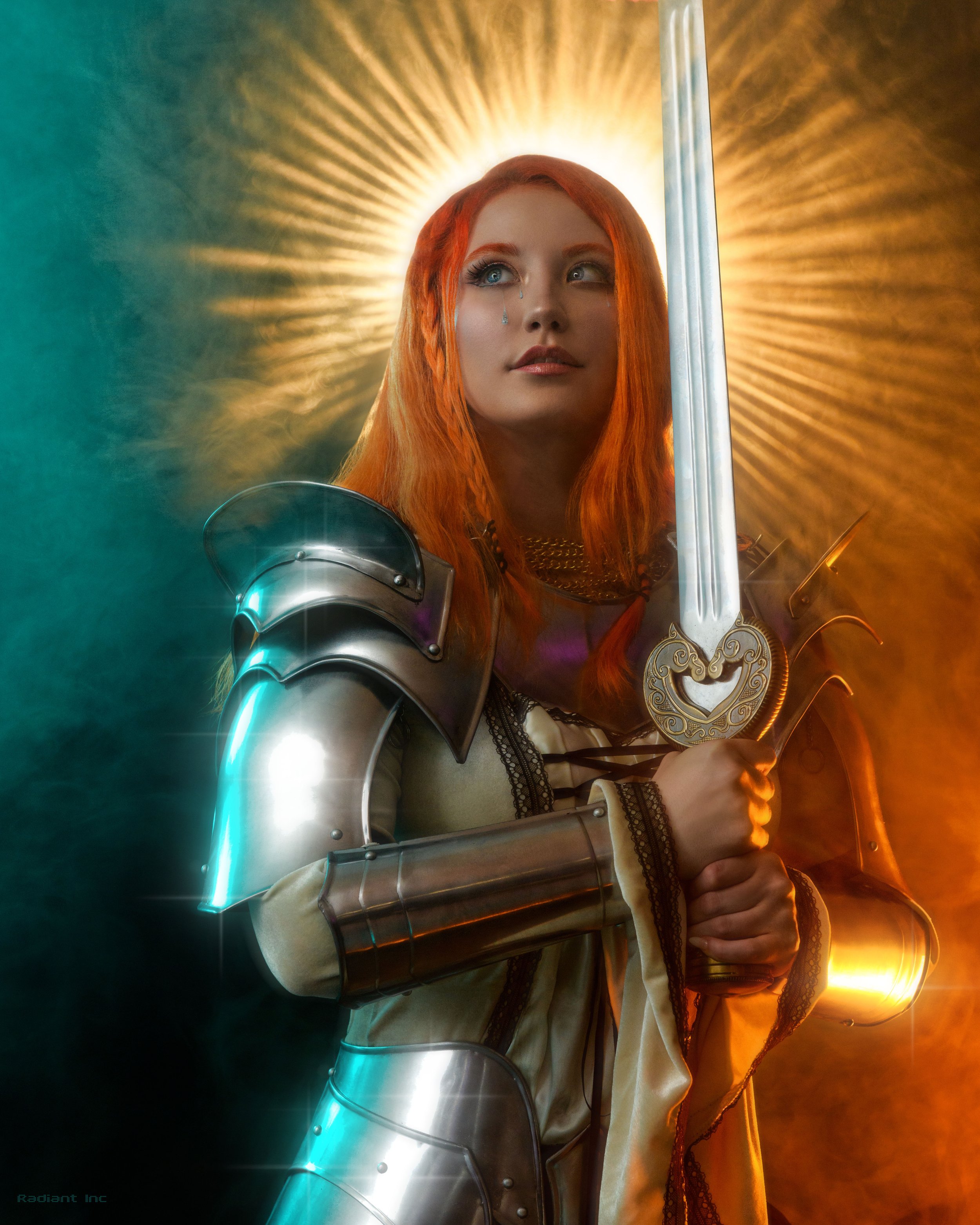 A woman in knight armor holding a glowing sword with a radiant halo light behind her head.