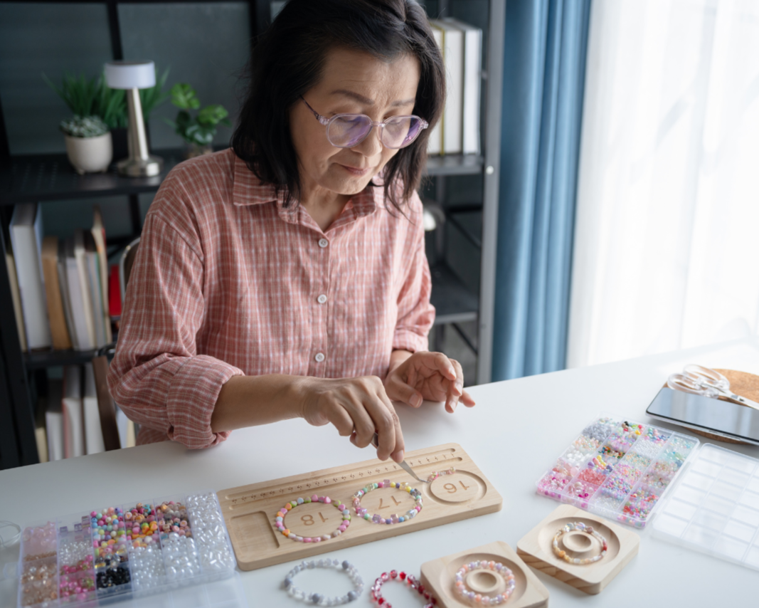 Adult woman completing a fine motor and sensory task with beads during an occupational therapy assessment.