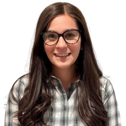 A woman with long brown hair, glasses, and a checkered shirt smiling at the camera.