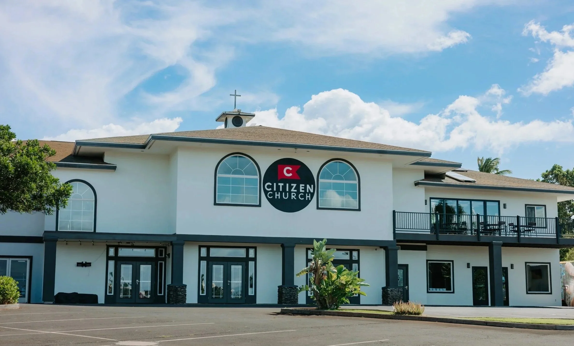 A two-story beige building with a sign that reads 'Citizen Church' on the front.