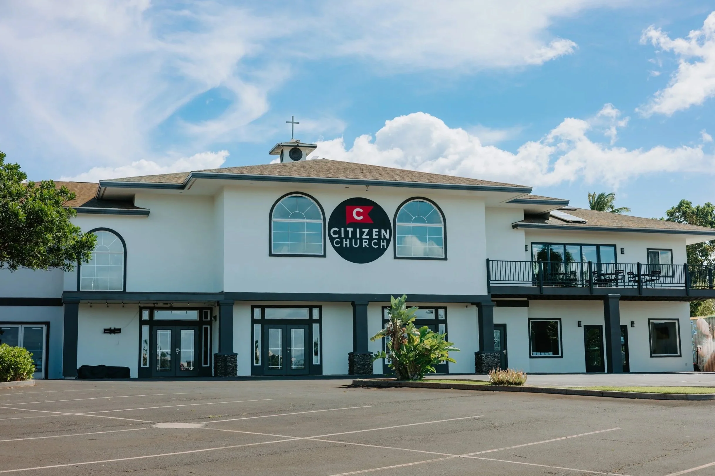 A two-story beige building with a sign that reads 'Citizen Church' on the front.
