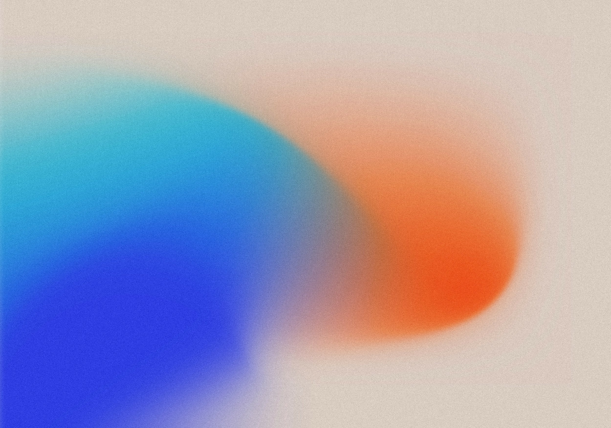 Blurry abstract background with blue, orange, and beige colors blending together.