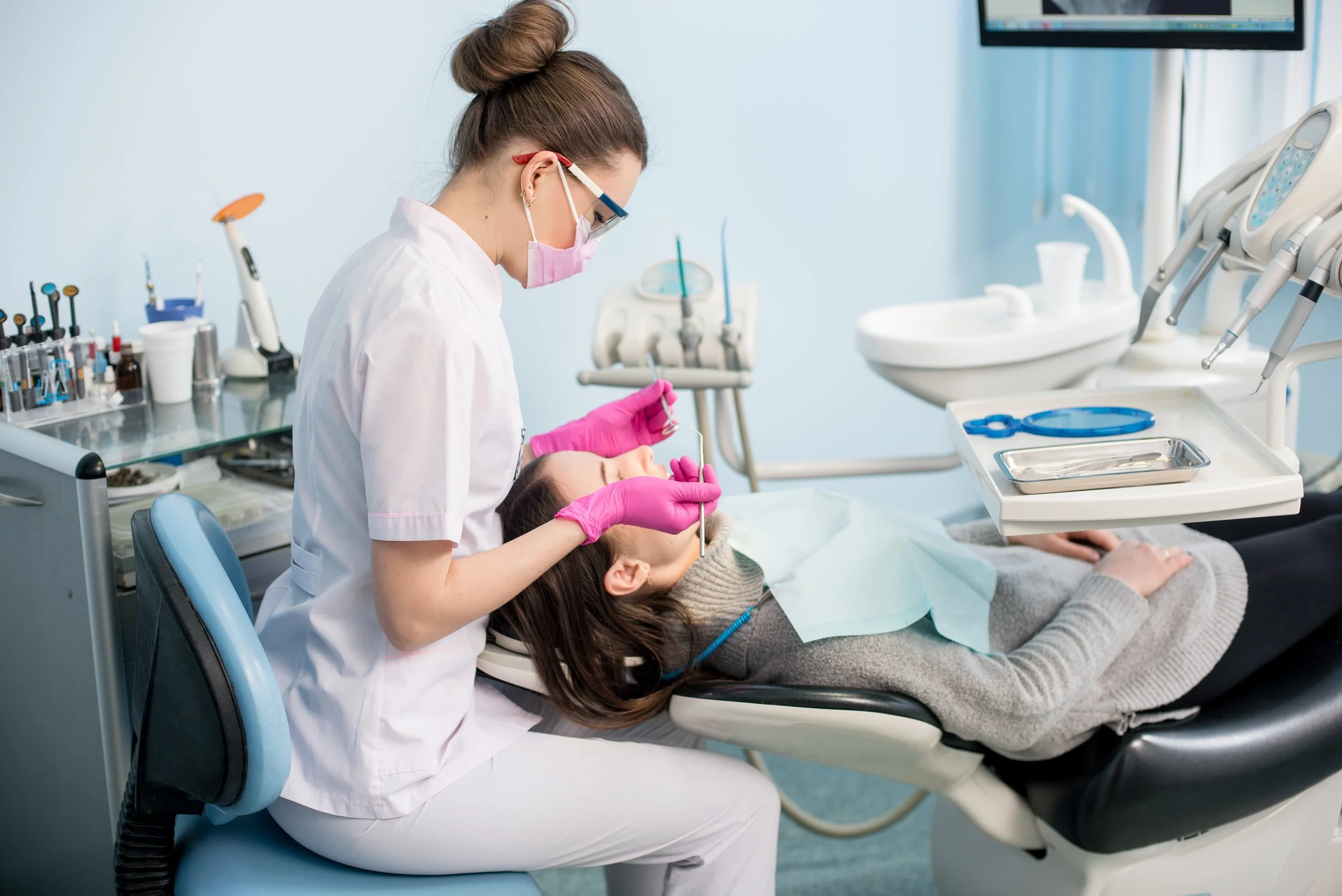 Dentist performing a dental procedure on a patient in a dental clinic.