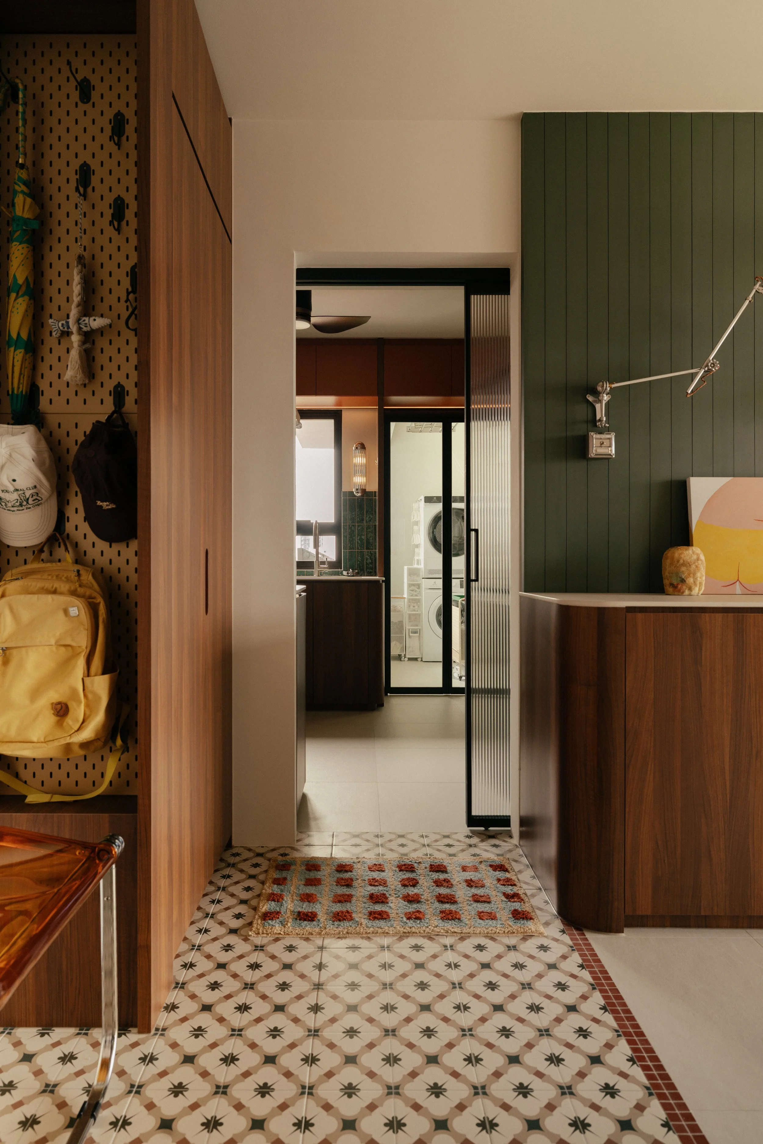 A mid century modern space designed by Unformn. Bright colors and patterns adds character in this cosy Foyer leading to the kitchen and dry pantry.
