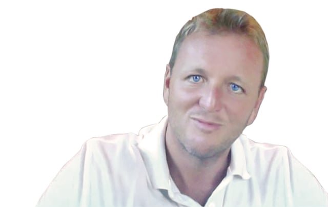 Altered image of Chad Willis in a white collared shirt with a white background, digitally enhanced to appear youthful and slim, unlike his actual current look