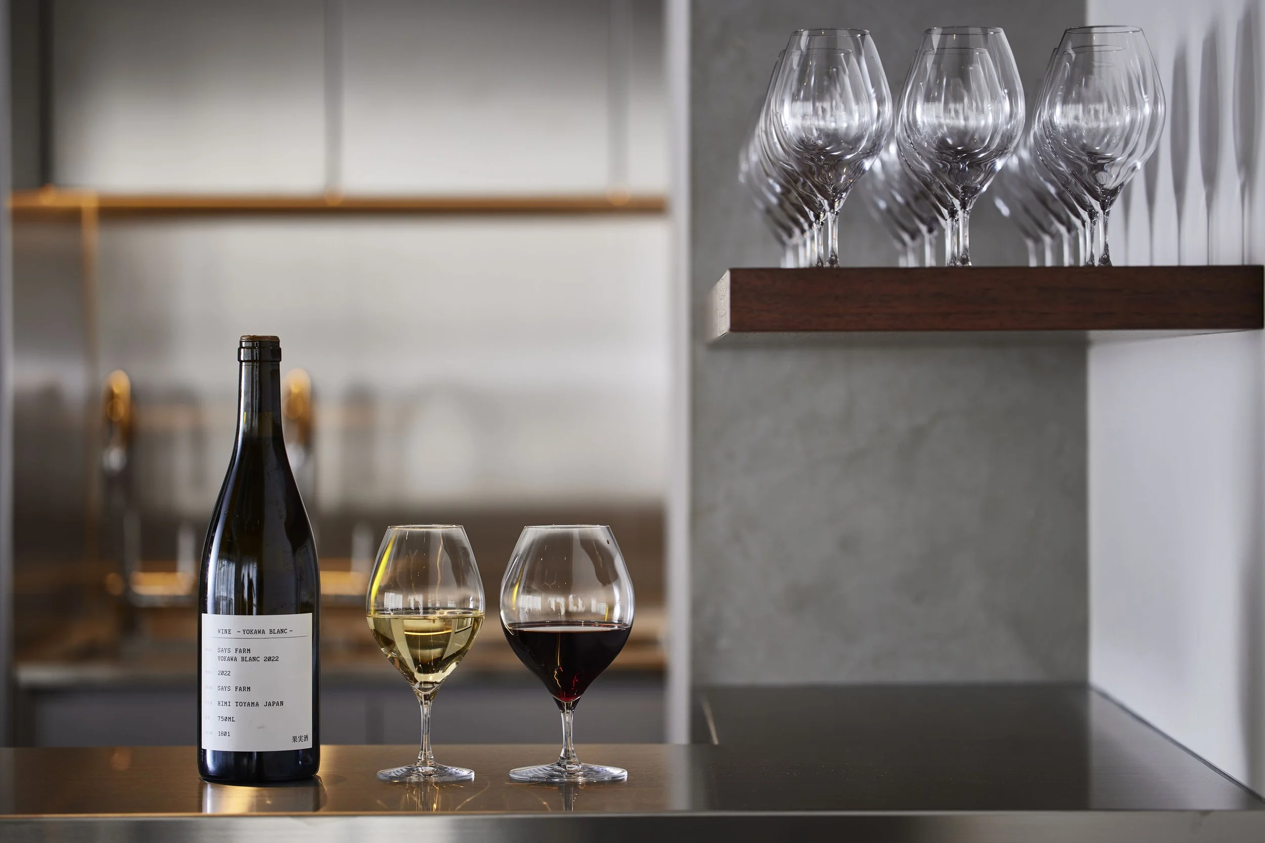 Two glasses of Japanese wine on the bar counter at Three Grapes Tokyo