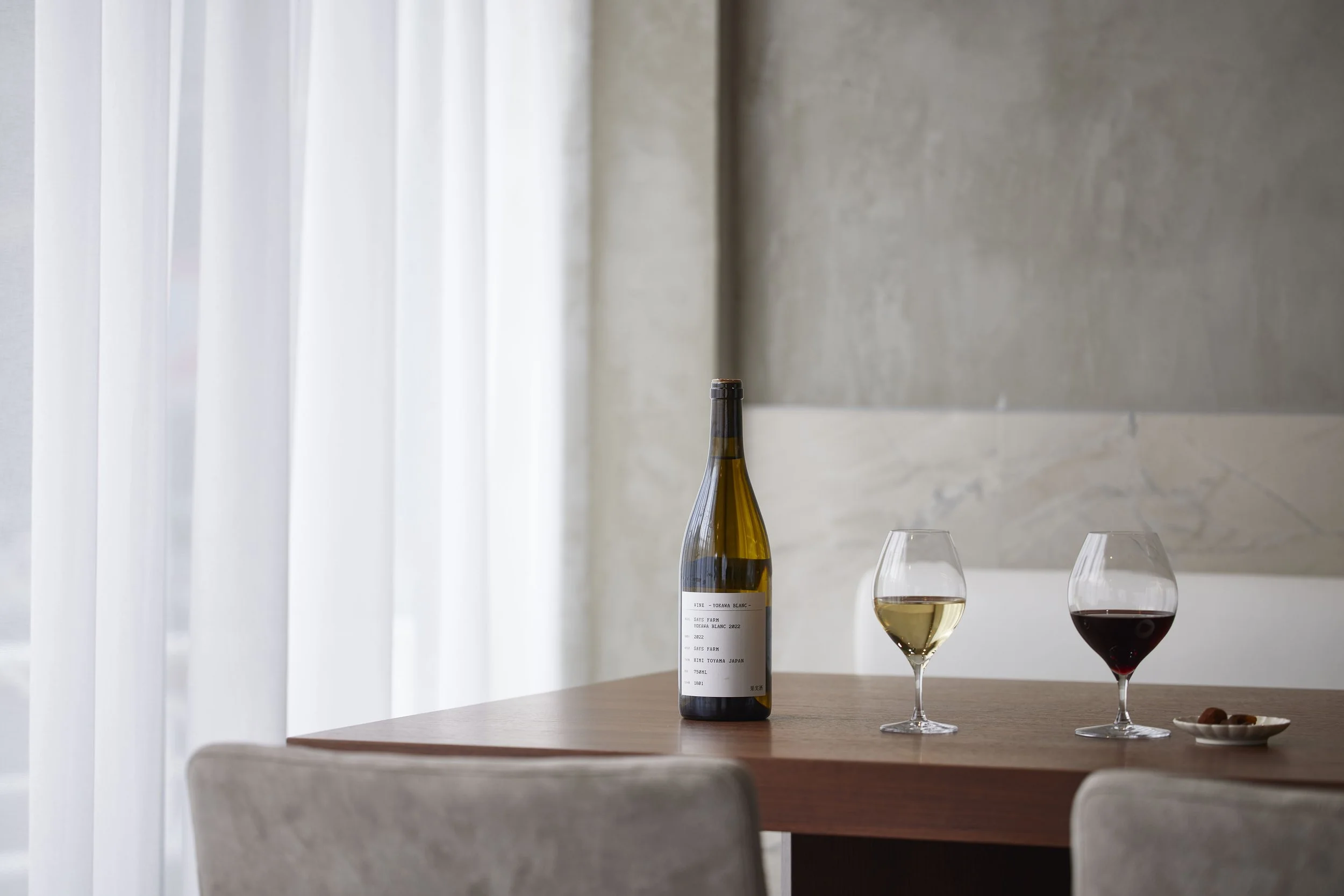 Table set for a Japanese wine tasting at Three Grapes in Tokyo with two wine glasses
