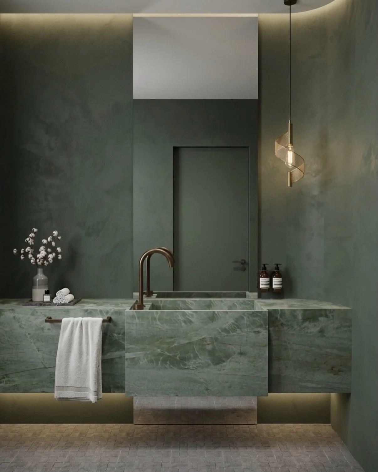 Moody powder room with dark green limewash walls and green stone vanity