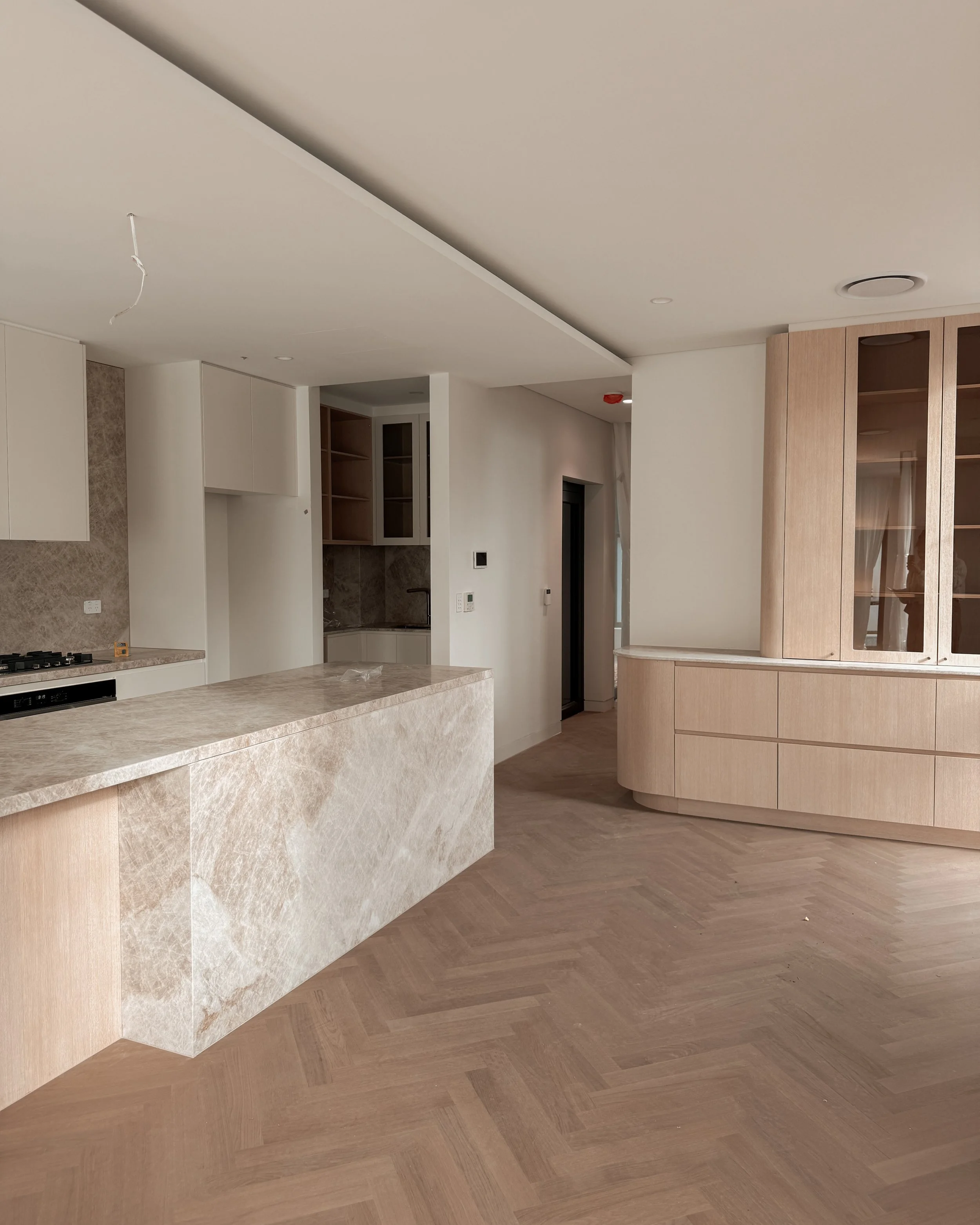 TID Studio. Contemporary kitchen design, taj mahal island, pantry, dining, bar, neutral creamy colour palette. Interior design Sydney. New build Five Dock