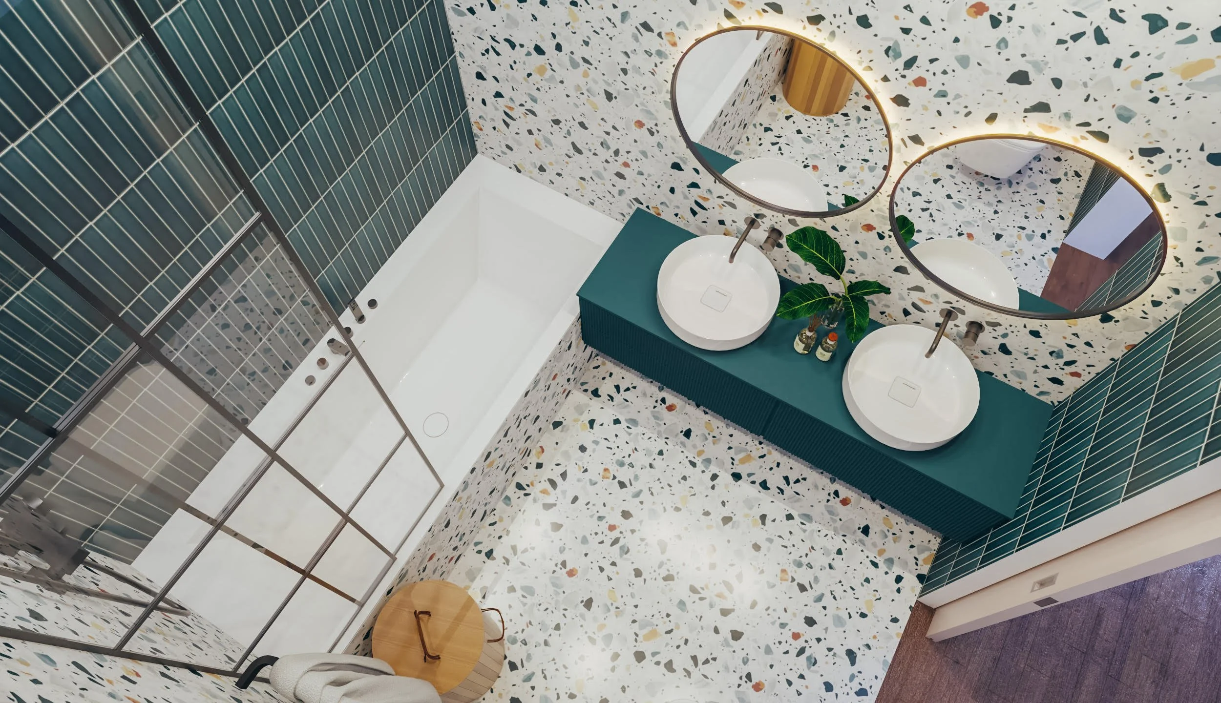 Kids’ bathroom with terrazzo tiles, round mirrors, green vanity, and black-framed bath screen