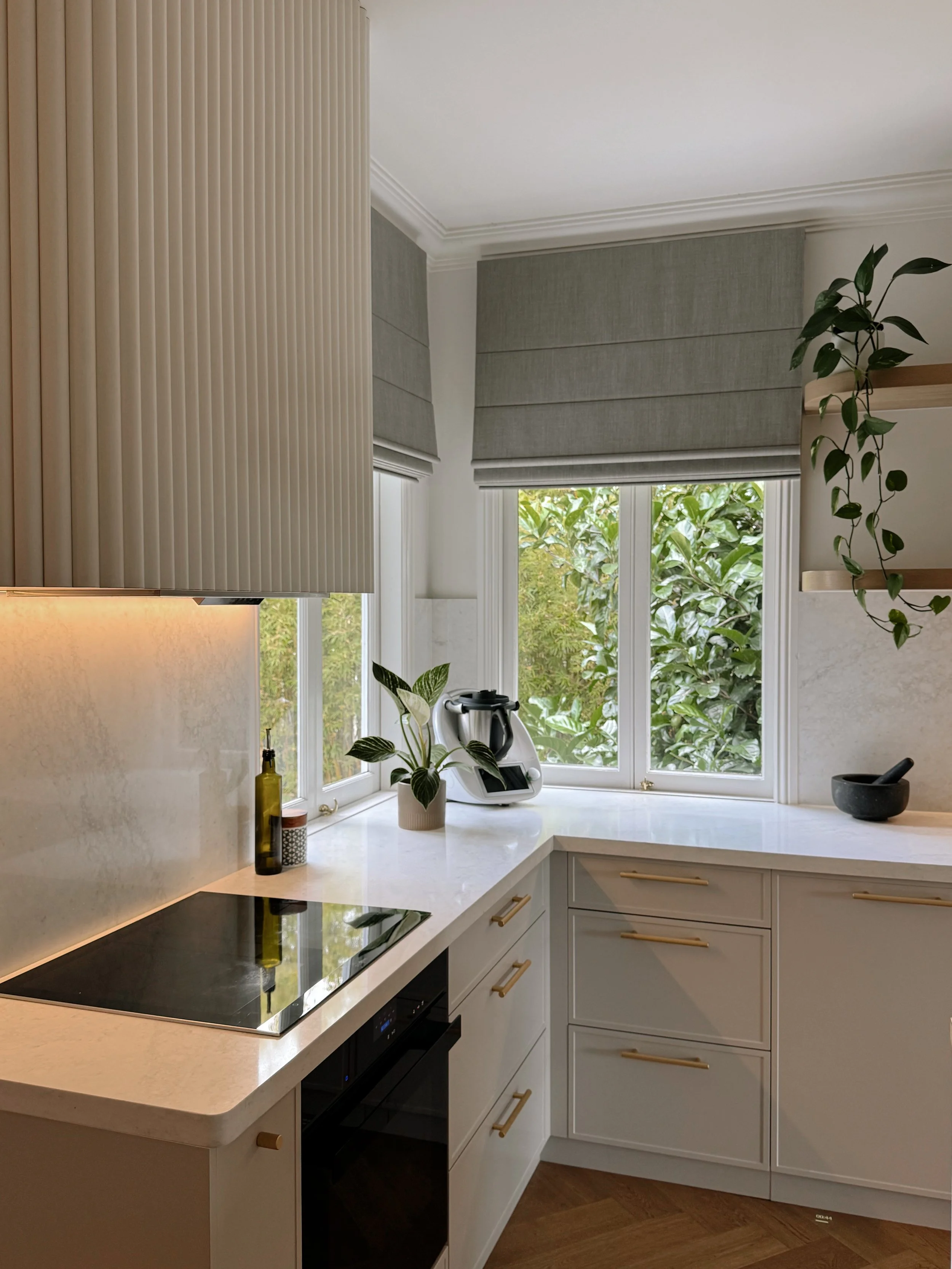 Modern Brisbane kitchen render showing curved island, warm timber tones and integrated appliances