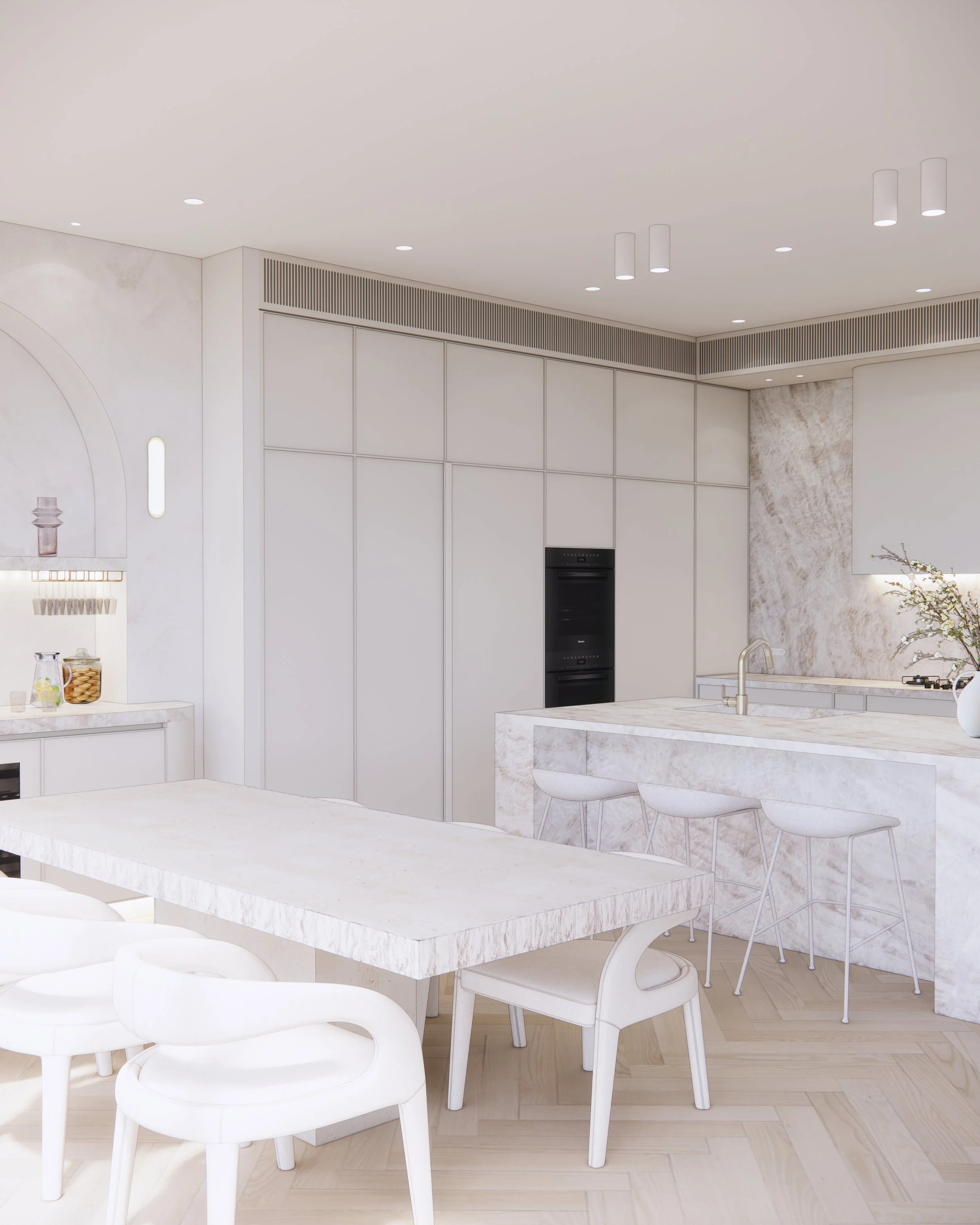 Open-plan kitchen and bar area featuring soft neutral palette and sculptural stone island