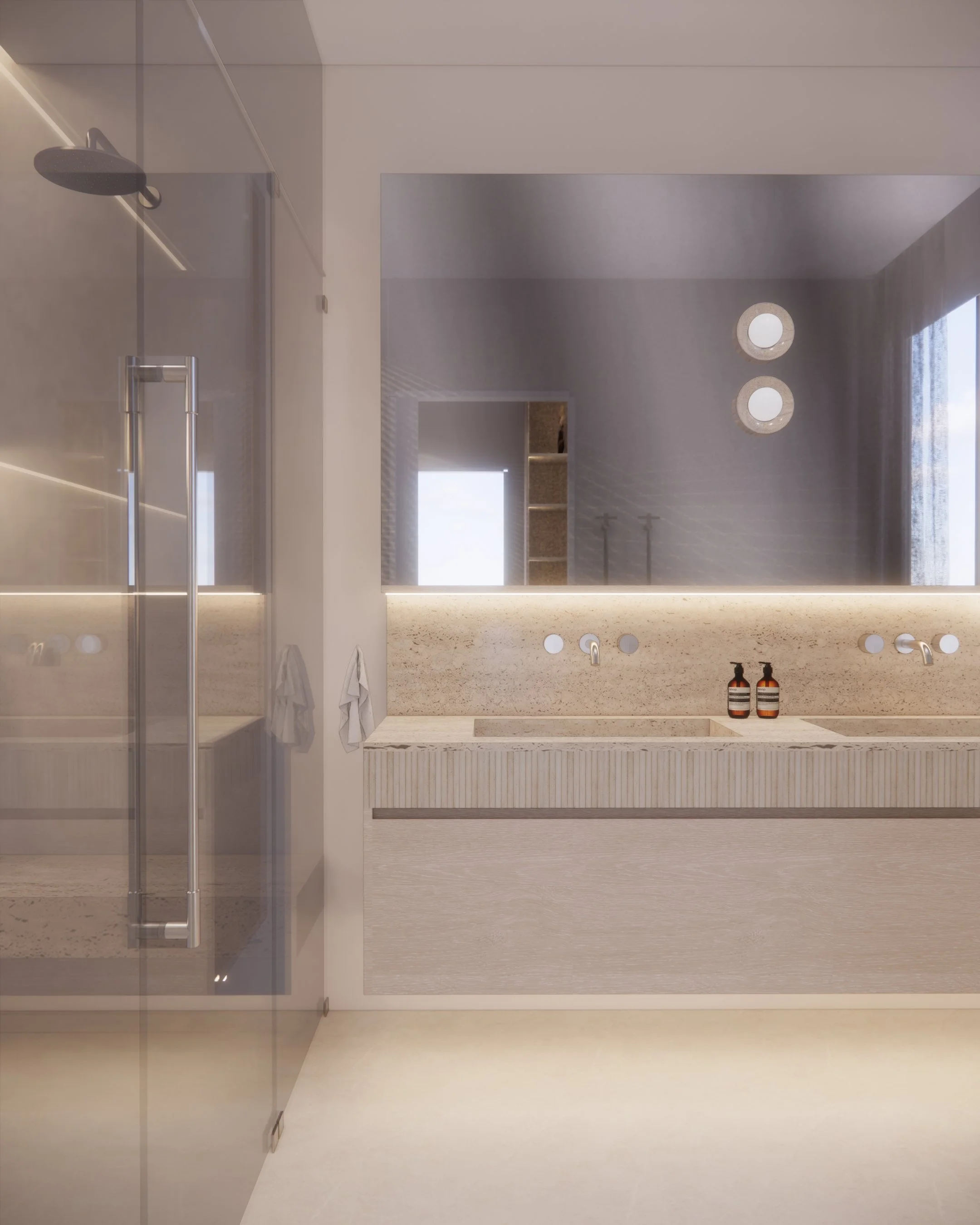 Contemporary ensuite with dual rainfall showers, floating stone vanity, soft integrated lighting, and double vanity with fluted stone detail.