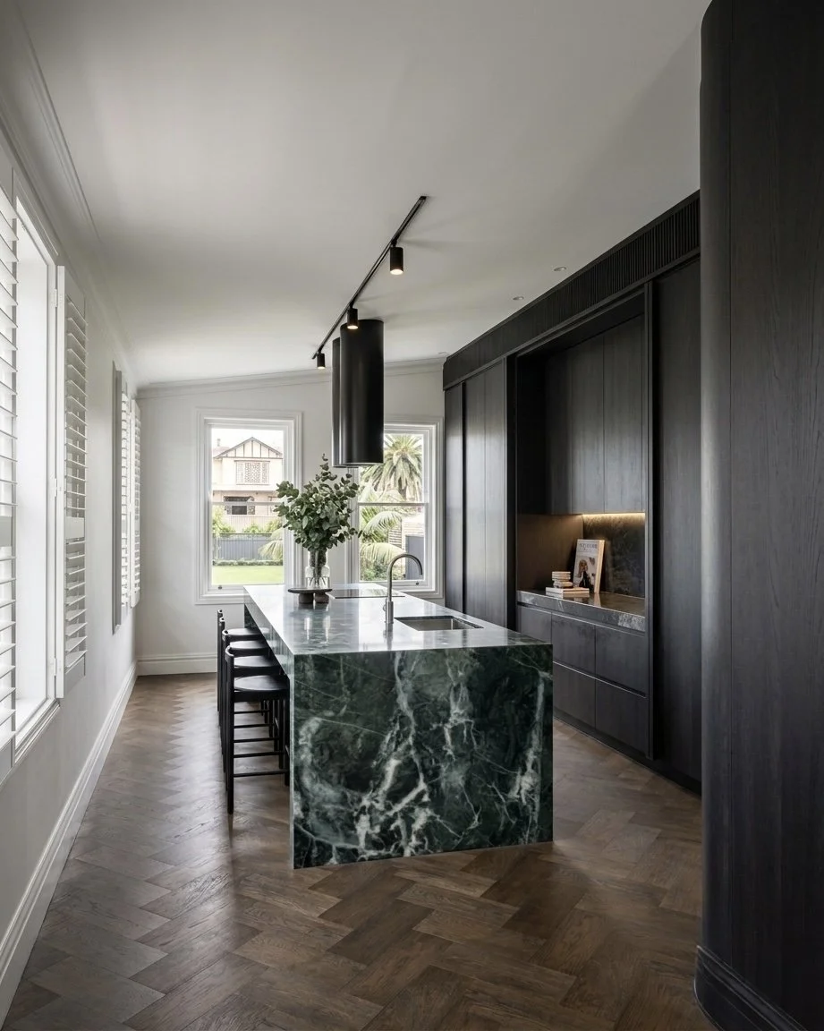 Full kitchen view showing dark joinery, green marble island, and sculptural lighting in Sydney terrace