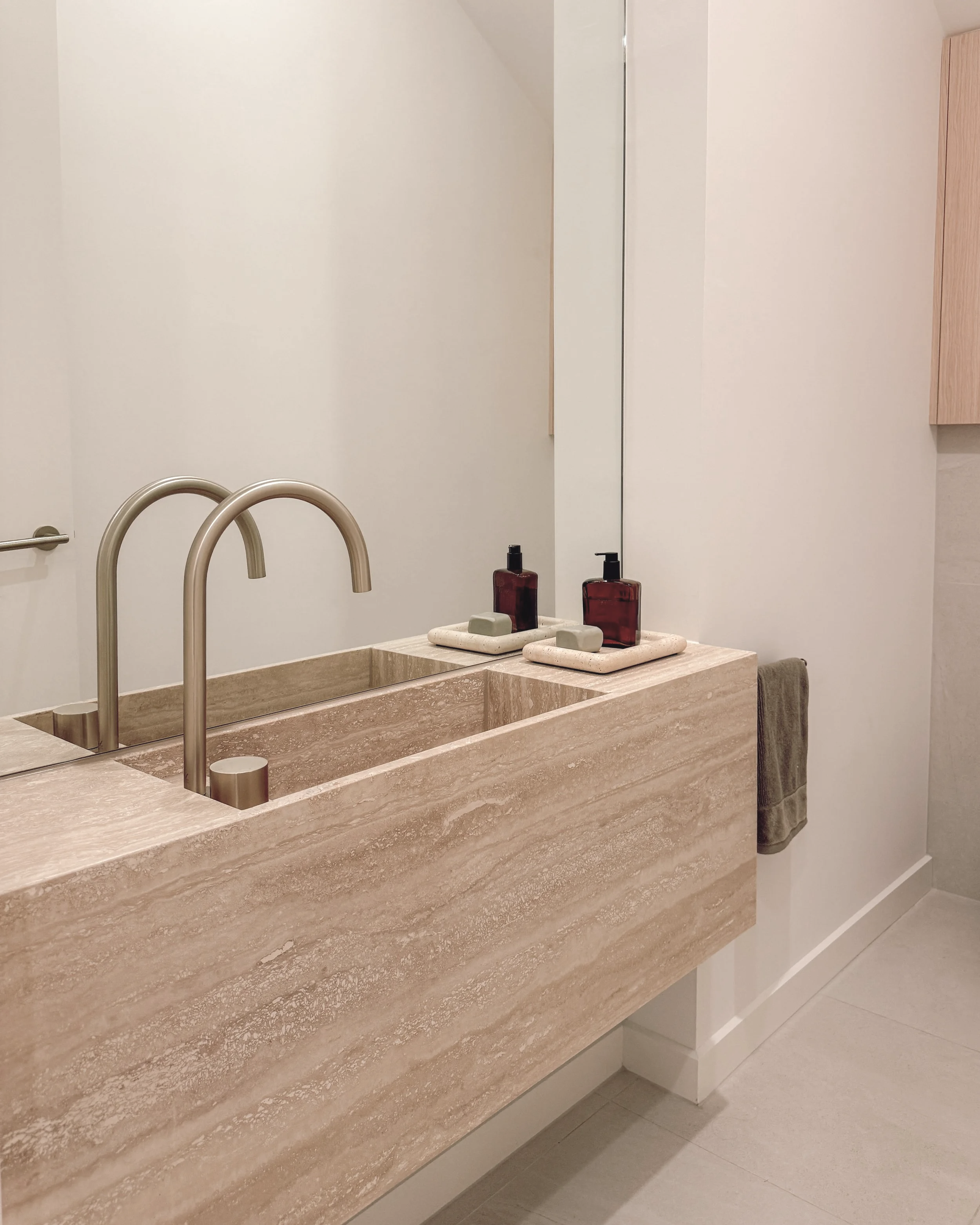 Contemporary Powder Room with custom travertine stone sink in Melbourne new-build. Designed by TID Studio, interior design in Sydney