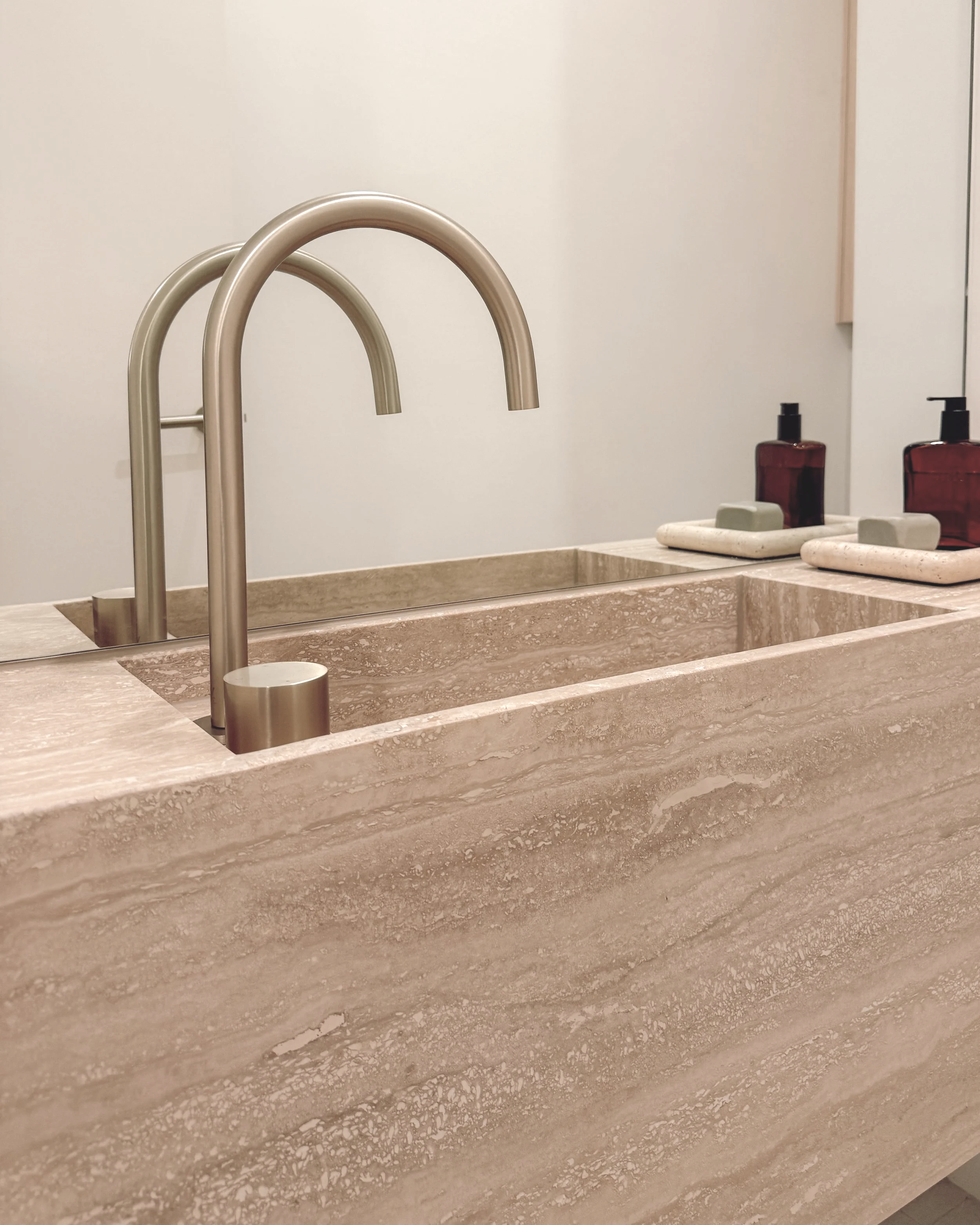 Contemporary Powder Room with custom travertine stone sink in Melbourne new-build. Designed by TID Studio, interior design in Sydney