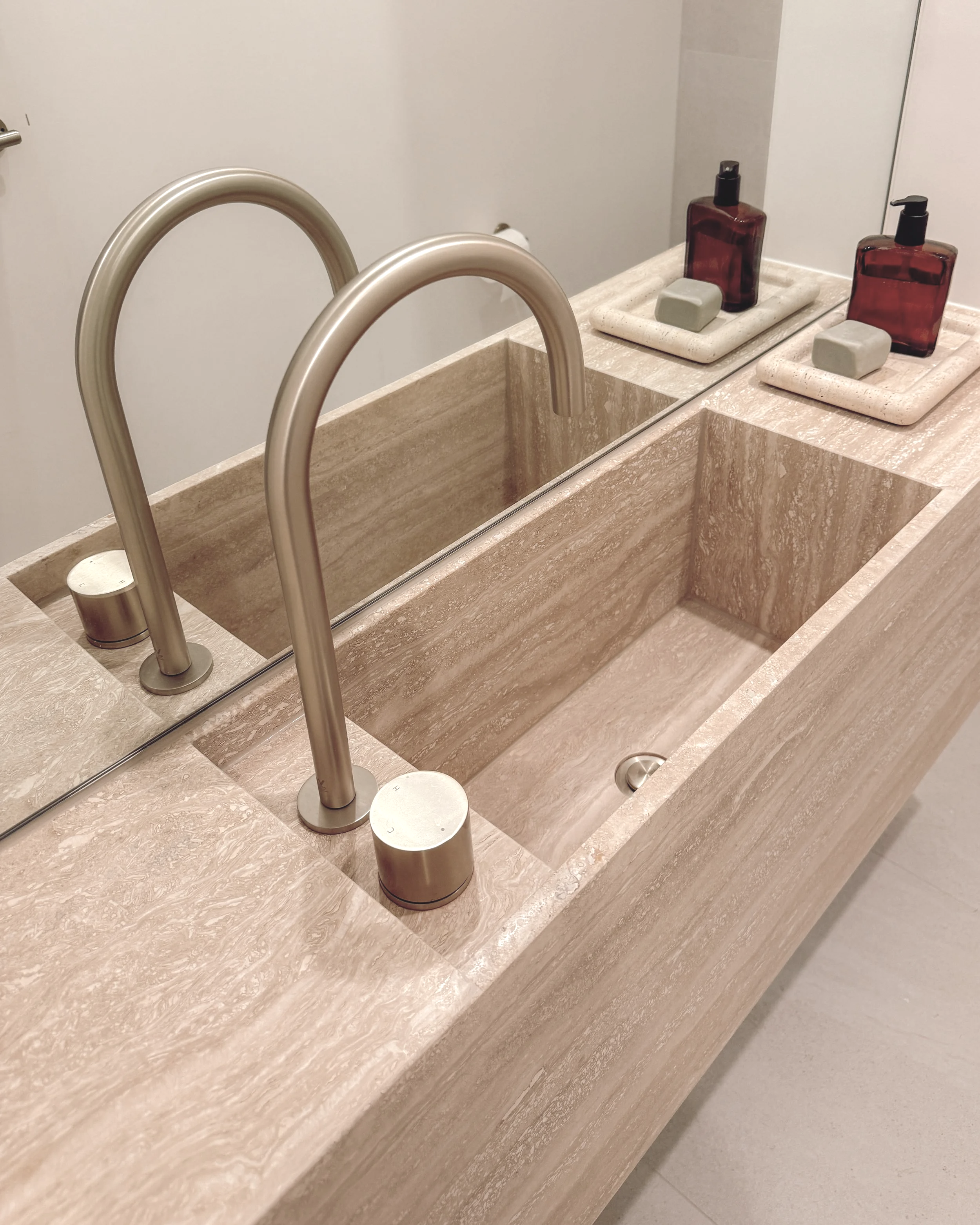 Contemporary Powder Room with custom travertine stone sink in Melbourne new-build. Designed by TID Studio, interior design in Sydney
