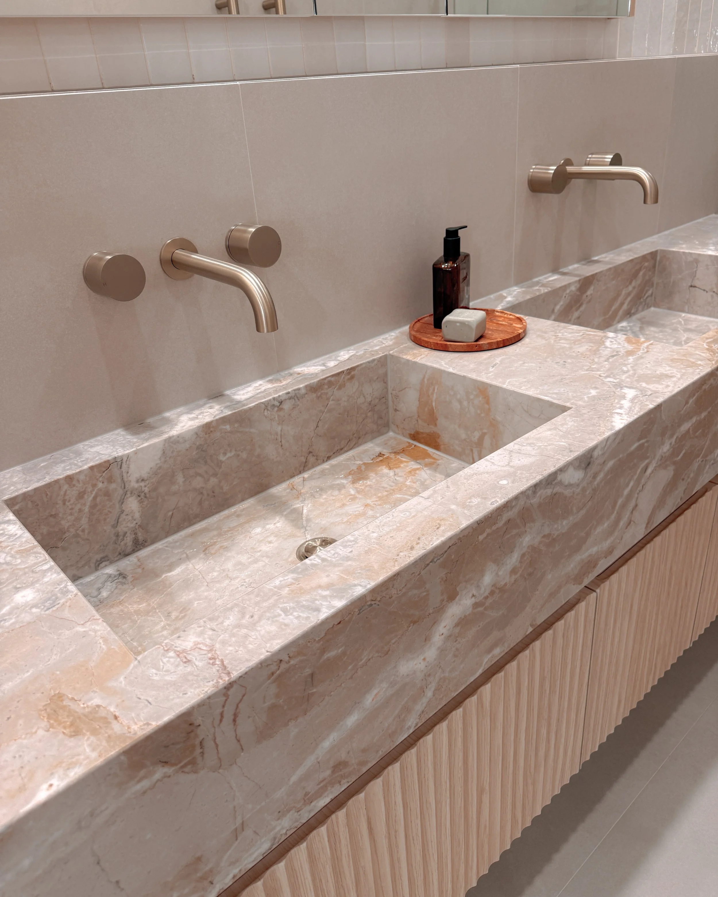 Contemporary bathroom with custom stone sink, fluted cabinets, double vanity in Melbourne new-build. Designed by TID Studio, interior design in Sydney