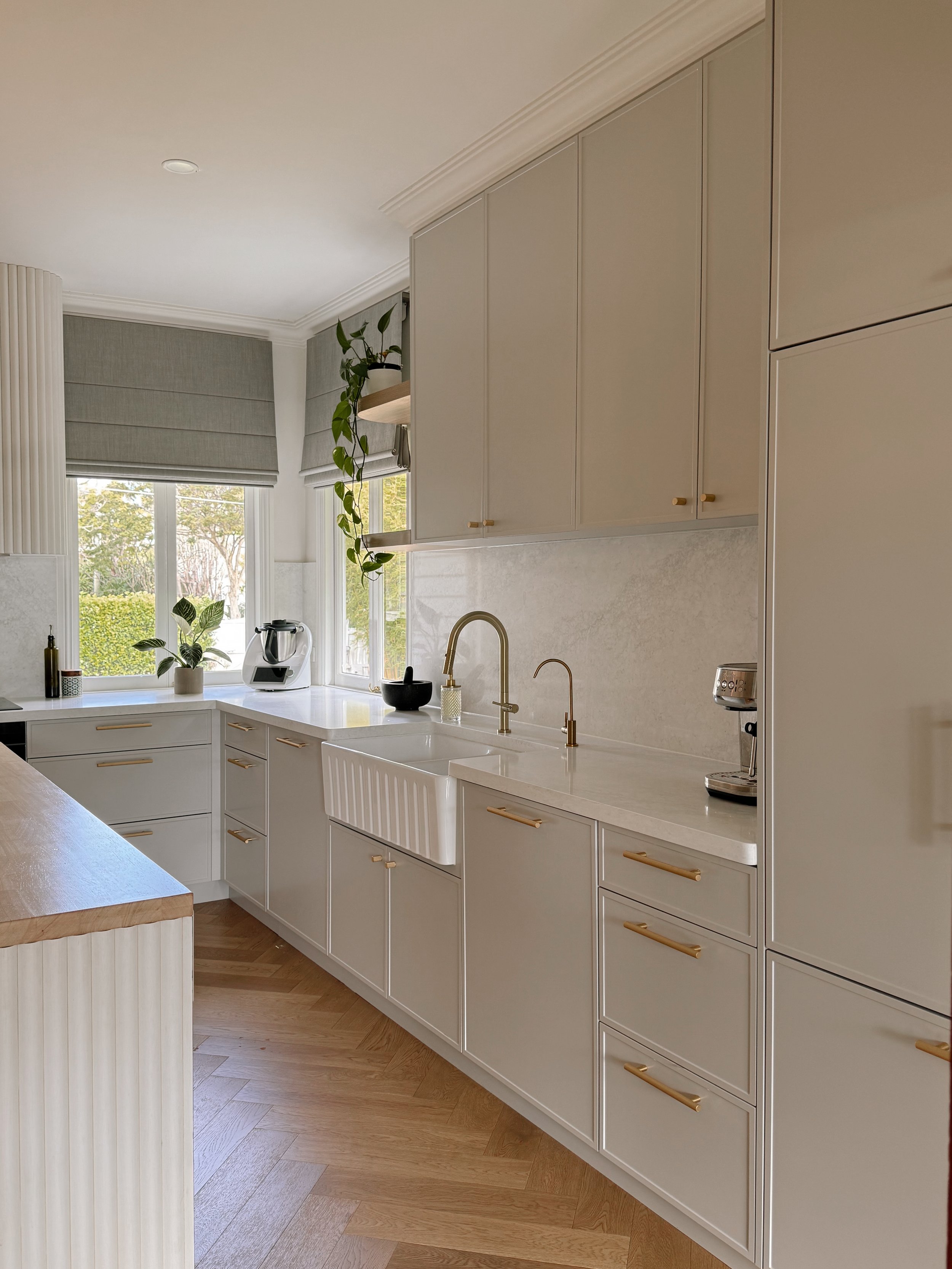 Modern Brisbane kitchen render showing curved island, warm timber tones and integrated appliances