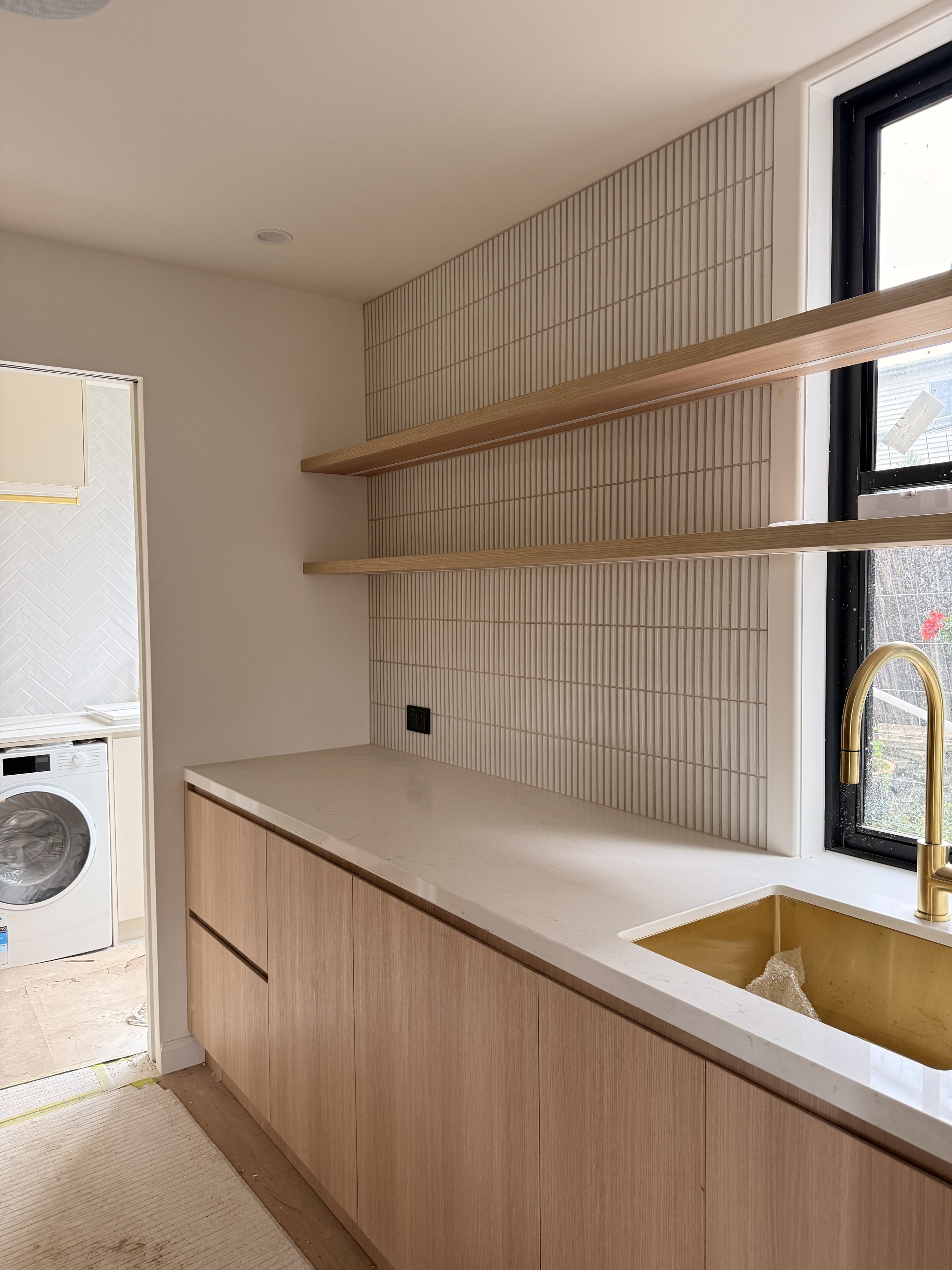 Modern coastal kitchen featuring adjacent butler's pantry, light timber cabinetry and neutral palette — Auriga Residence by TID Studio, interior designer Sydney