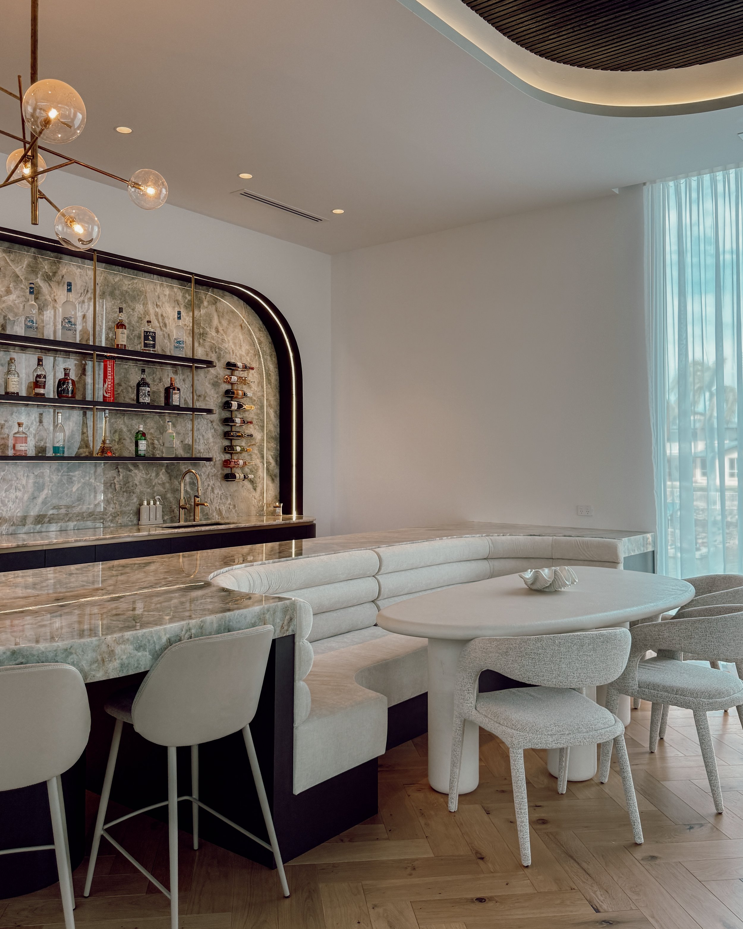 Modern coastal bar with island booth seating in a pool house in Brisbane, designed by TID Studio Sydney