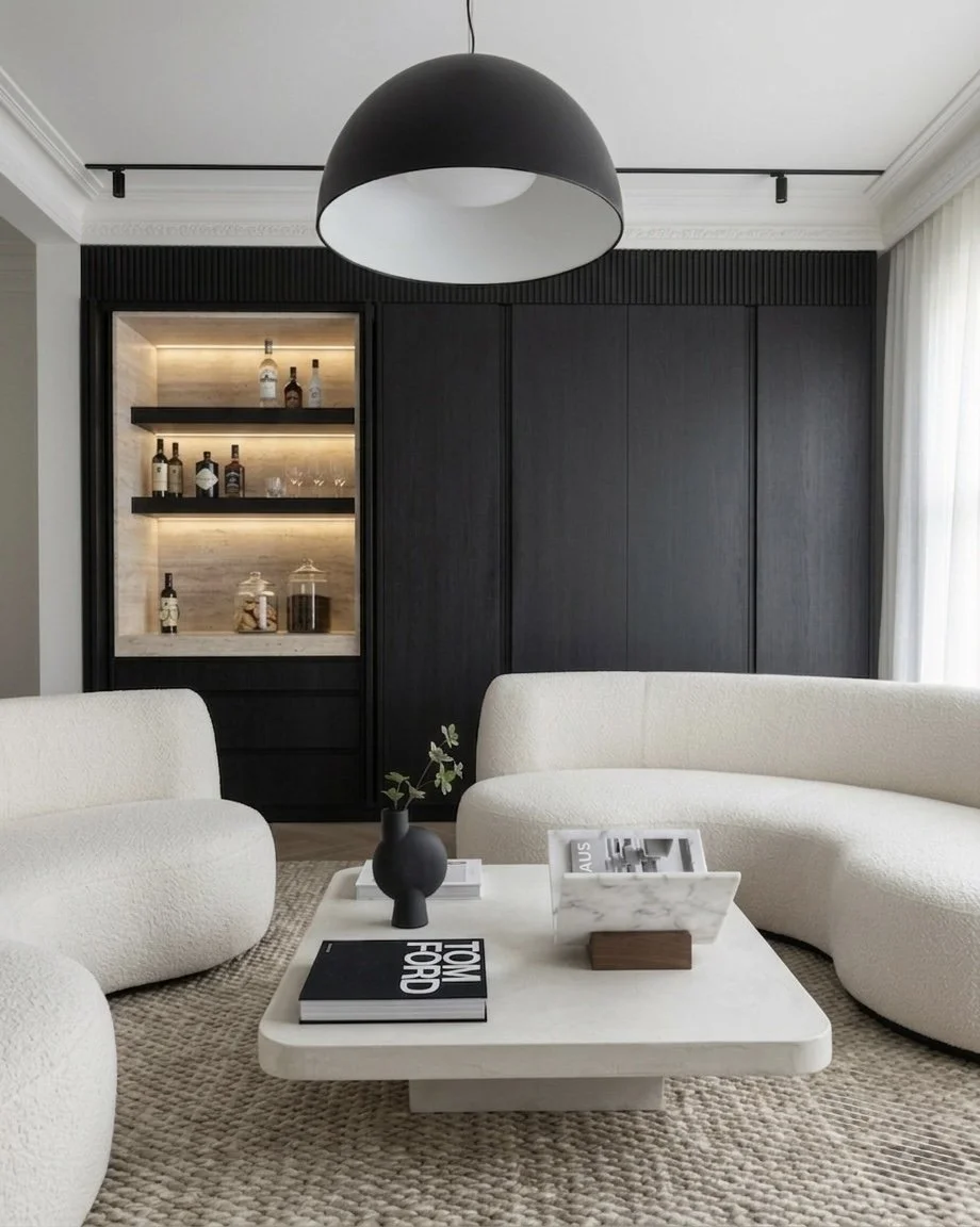 Lounge area with curved sofas and integrated bar shelves in modern Sydney terrace renovation