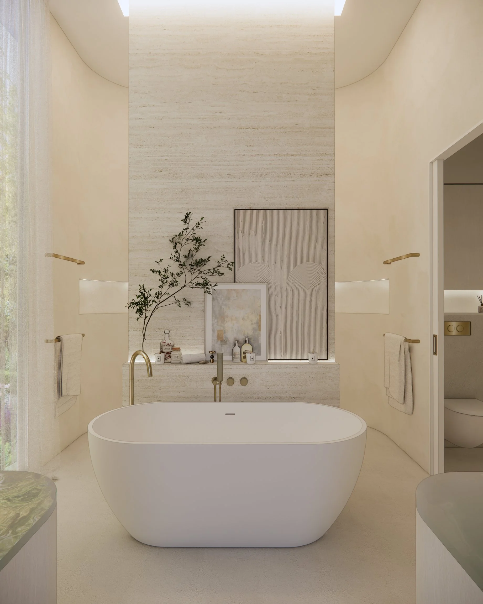 Neutral coastal ensuite with freestanding bath, travertine feature ledge, soft render walls and brushed brass tapware