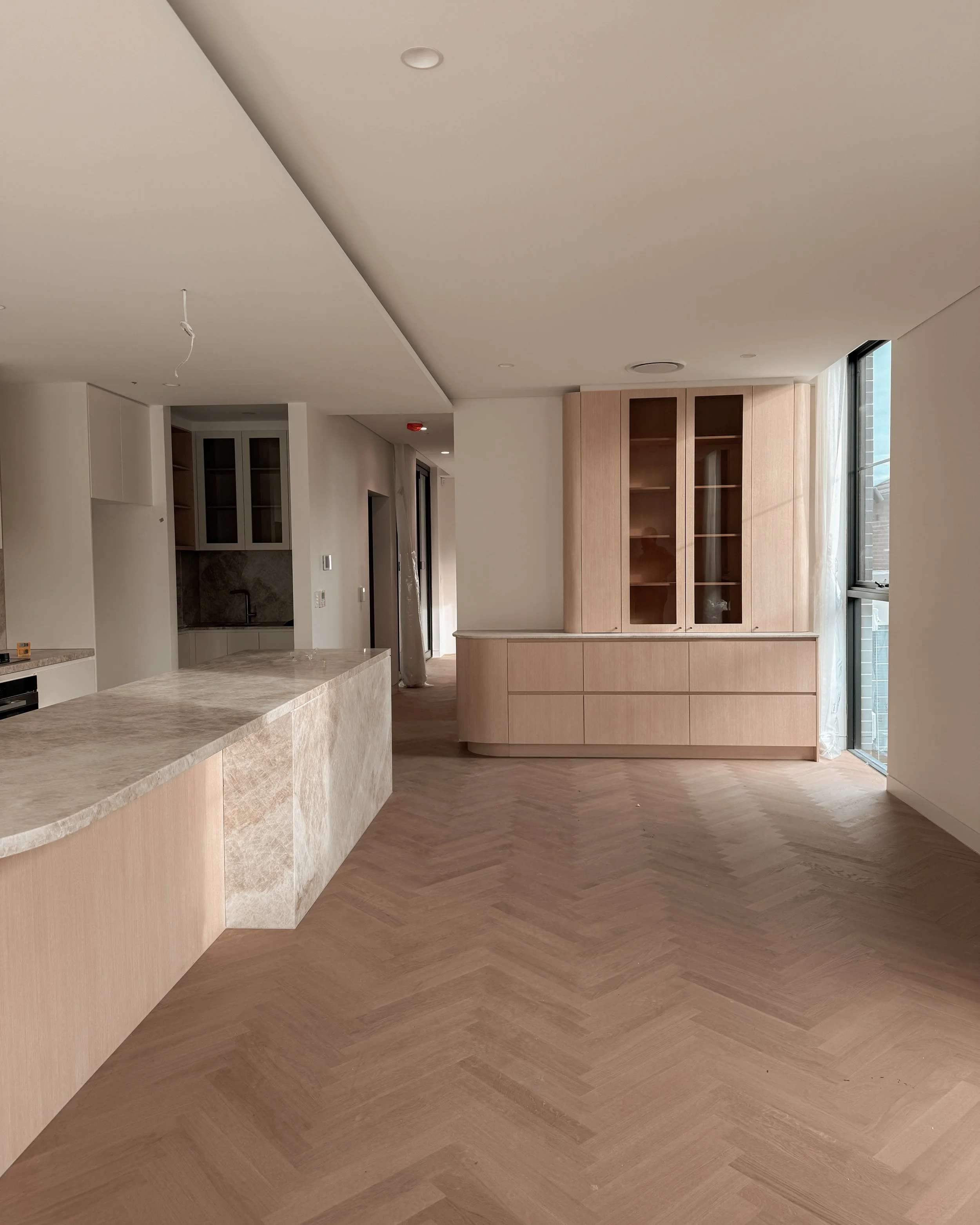 TID Studio. Contemporary kitchen design, taj mahal island, pantry, dining, bar, neutral creamy colour palette. Interior design Sydney. New build Five Dock
