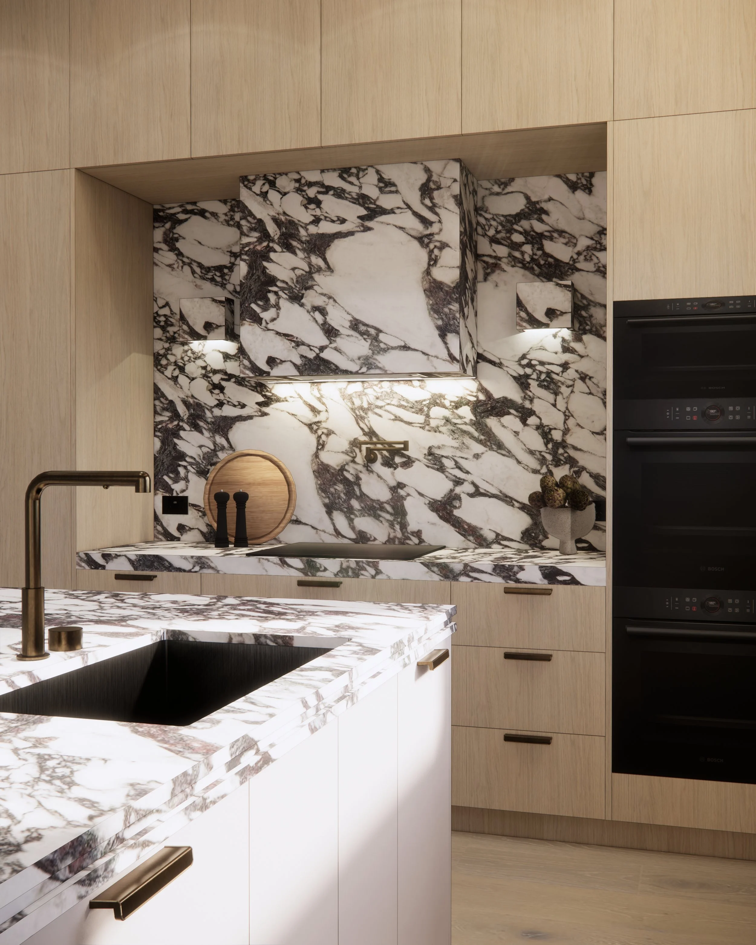 Close-up of dramatic veined marble splashback and sculptural stone rangehood detail
