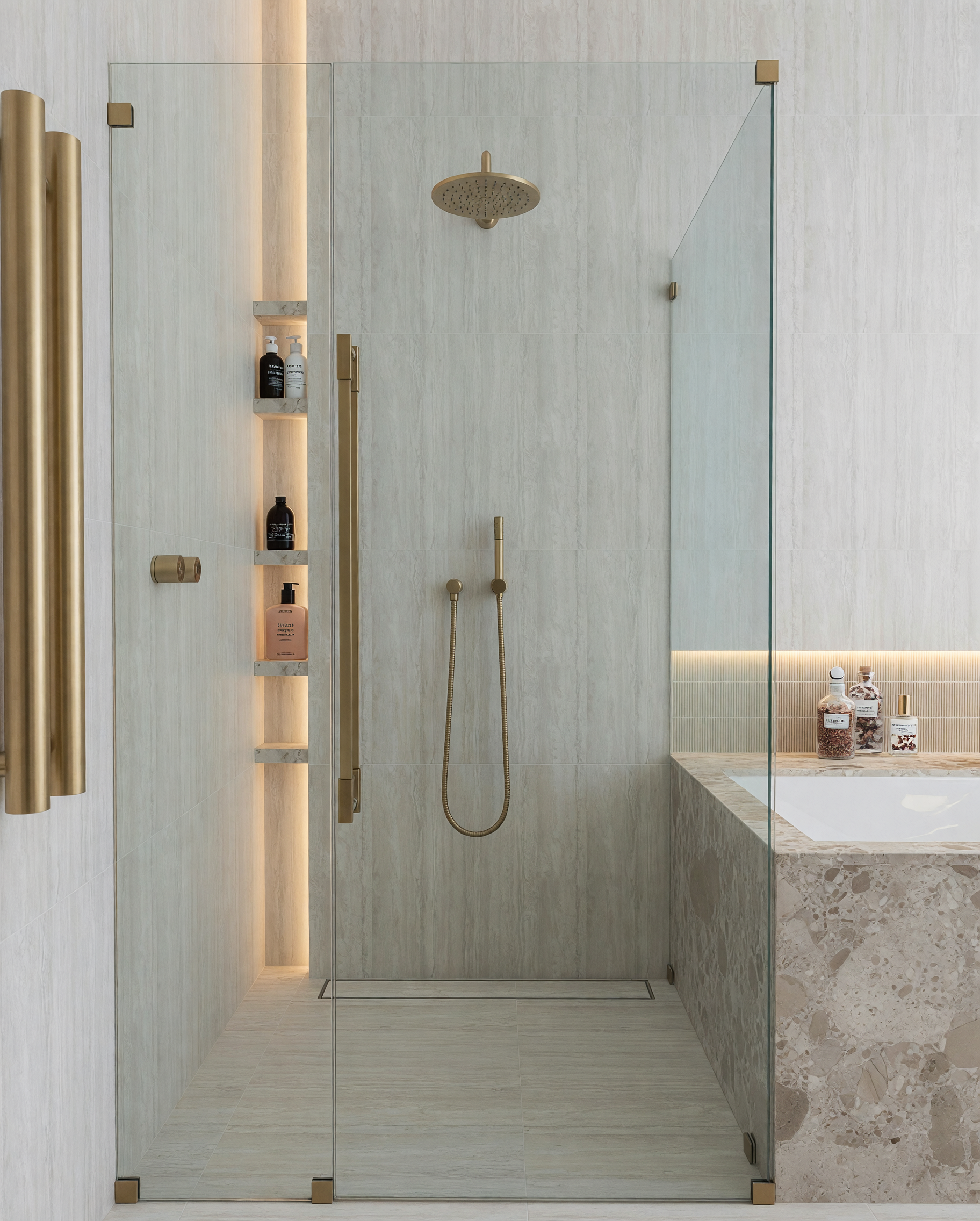 Modern bathroom with double vanity, shower, built-in bathtub, bronze fixtures and contemporary lighting, designed by TID Studio