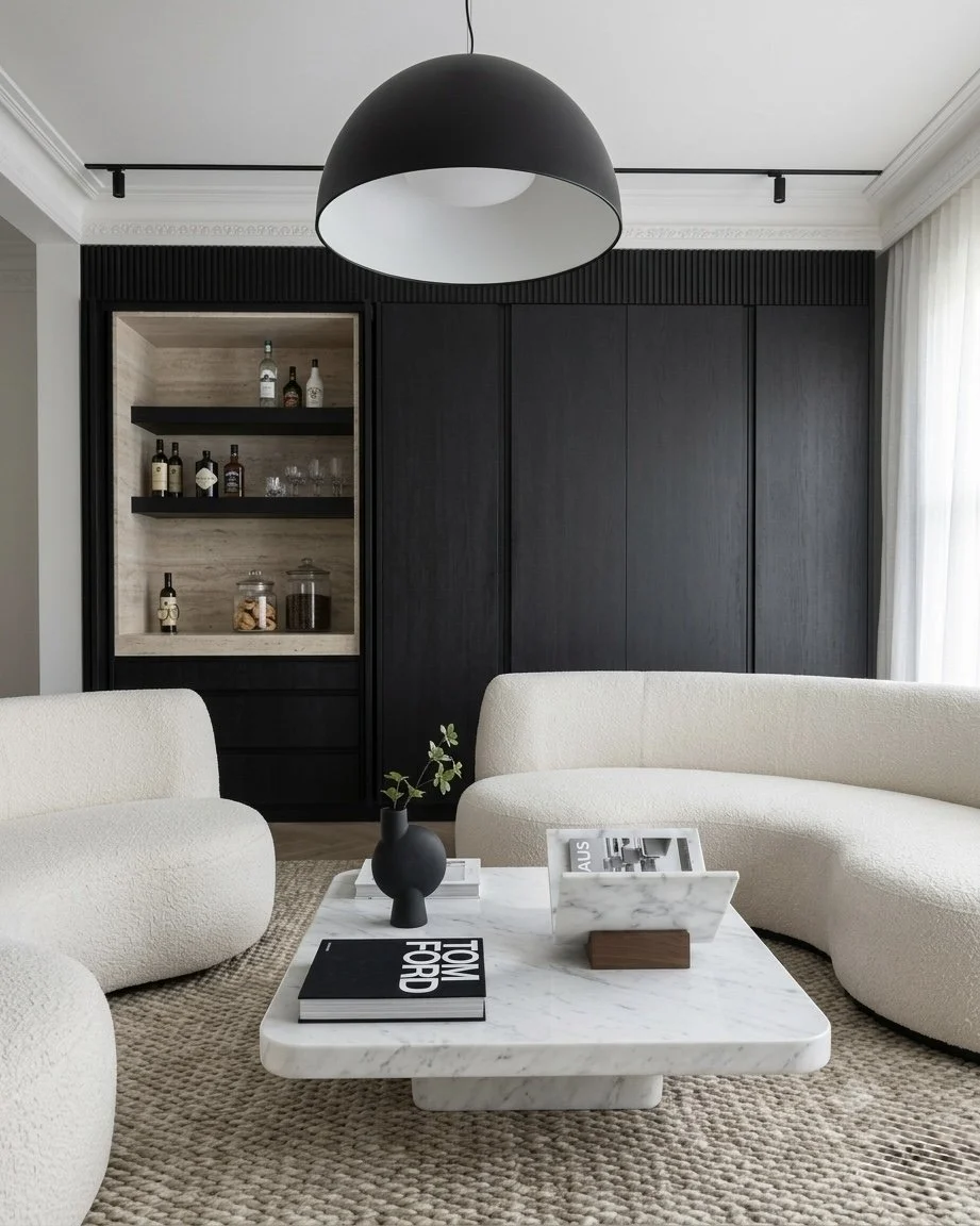 Lounge area with curved sofas and integrated bar shelves in modern Sydney terrace renovation