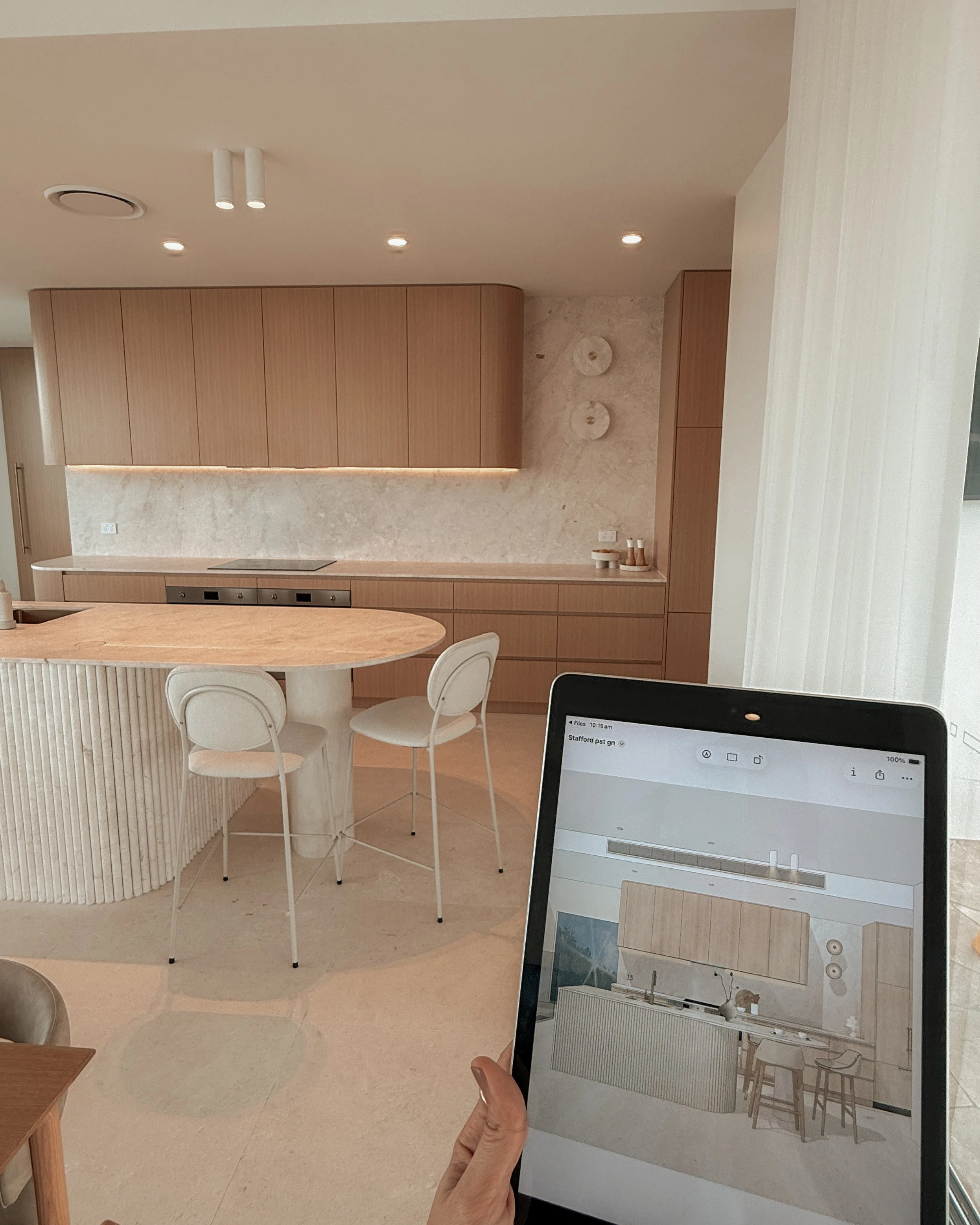 Modern coastal kitchen and pantry designed by TID Studio. Contemporary kitchen with curved cabinetry and fluted stone kitchen island. Sydney interior designer