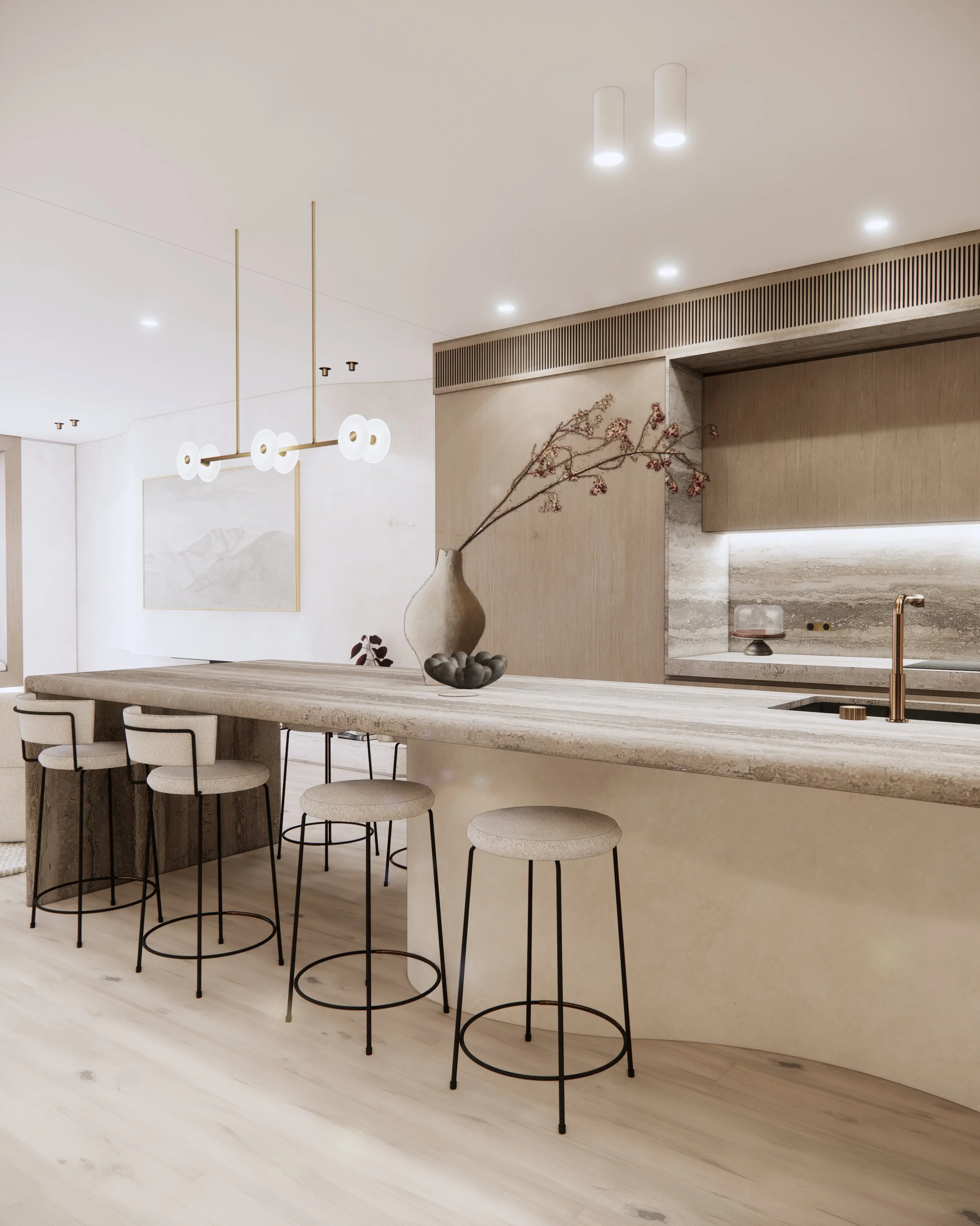 Open-plan kitchen with sculptural stone island, brass fixtures, and soft minimal design
