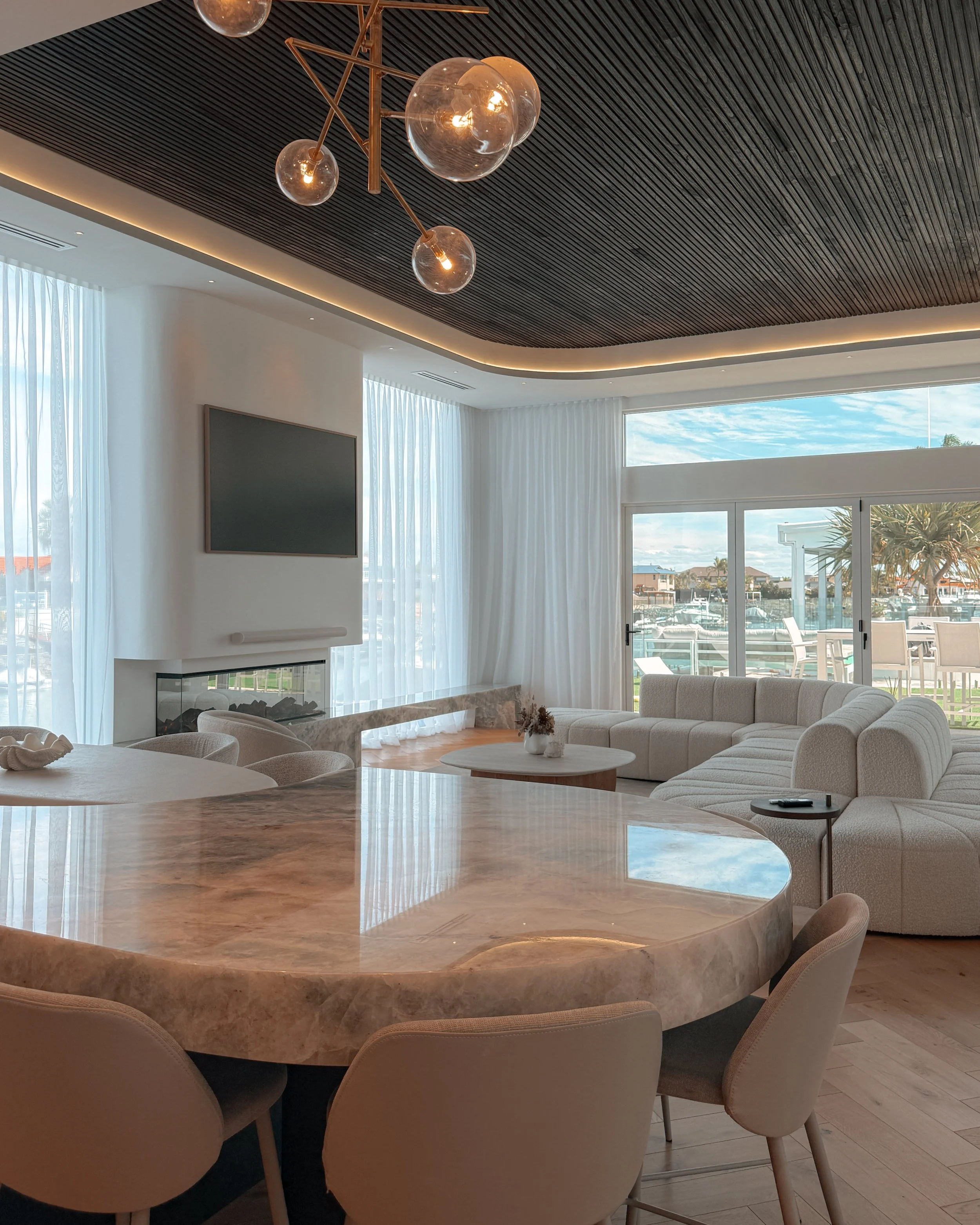 Modern coastal bar with island booth seating in a pool house in Brisbane, designed by TID Studio Sydney