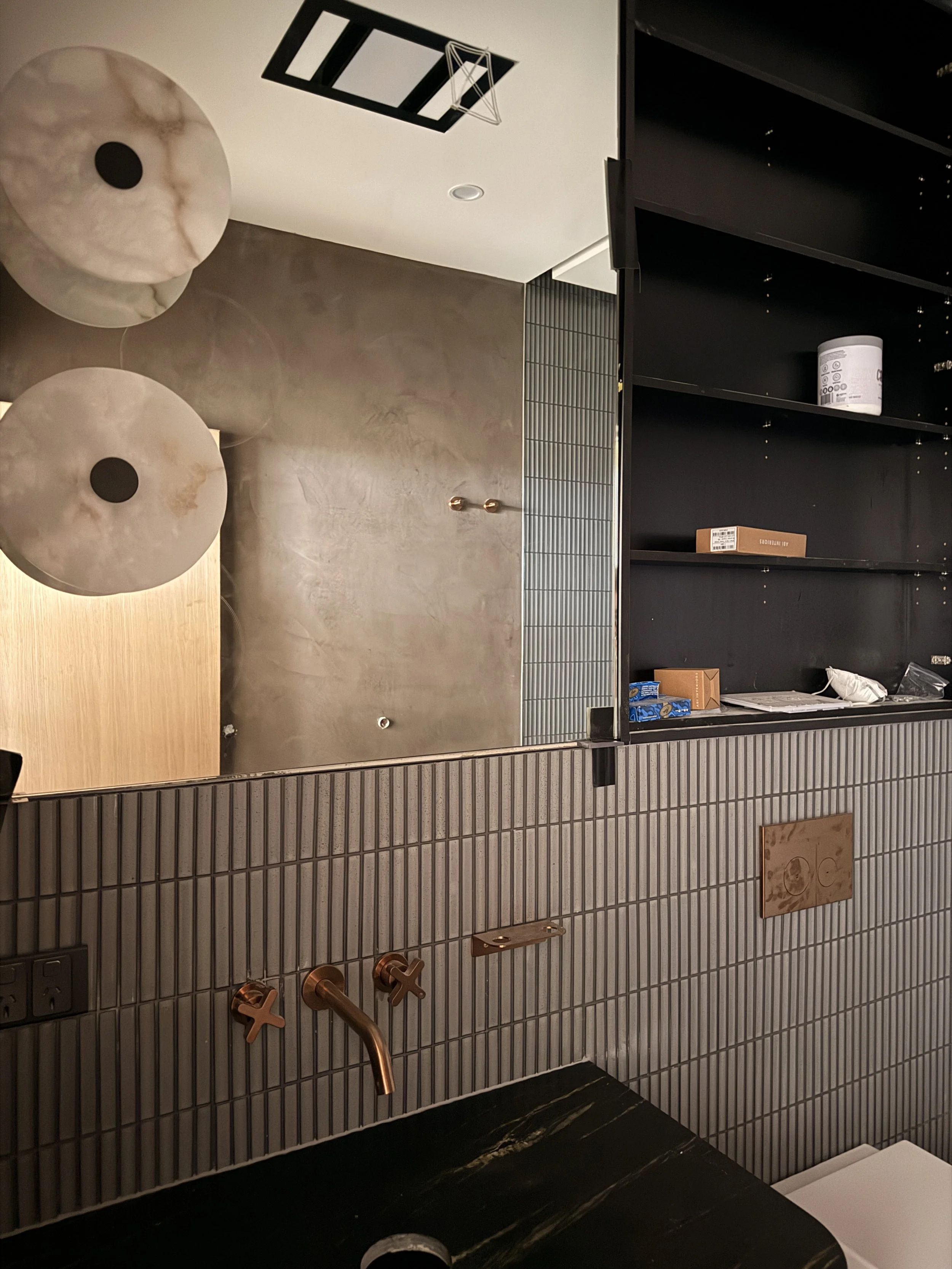 Modern powder room featuring curved dark, dramatic colour palette and brushed brass fixtures — Auriga Residence by TID Studio, interior designer Sydney