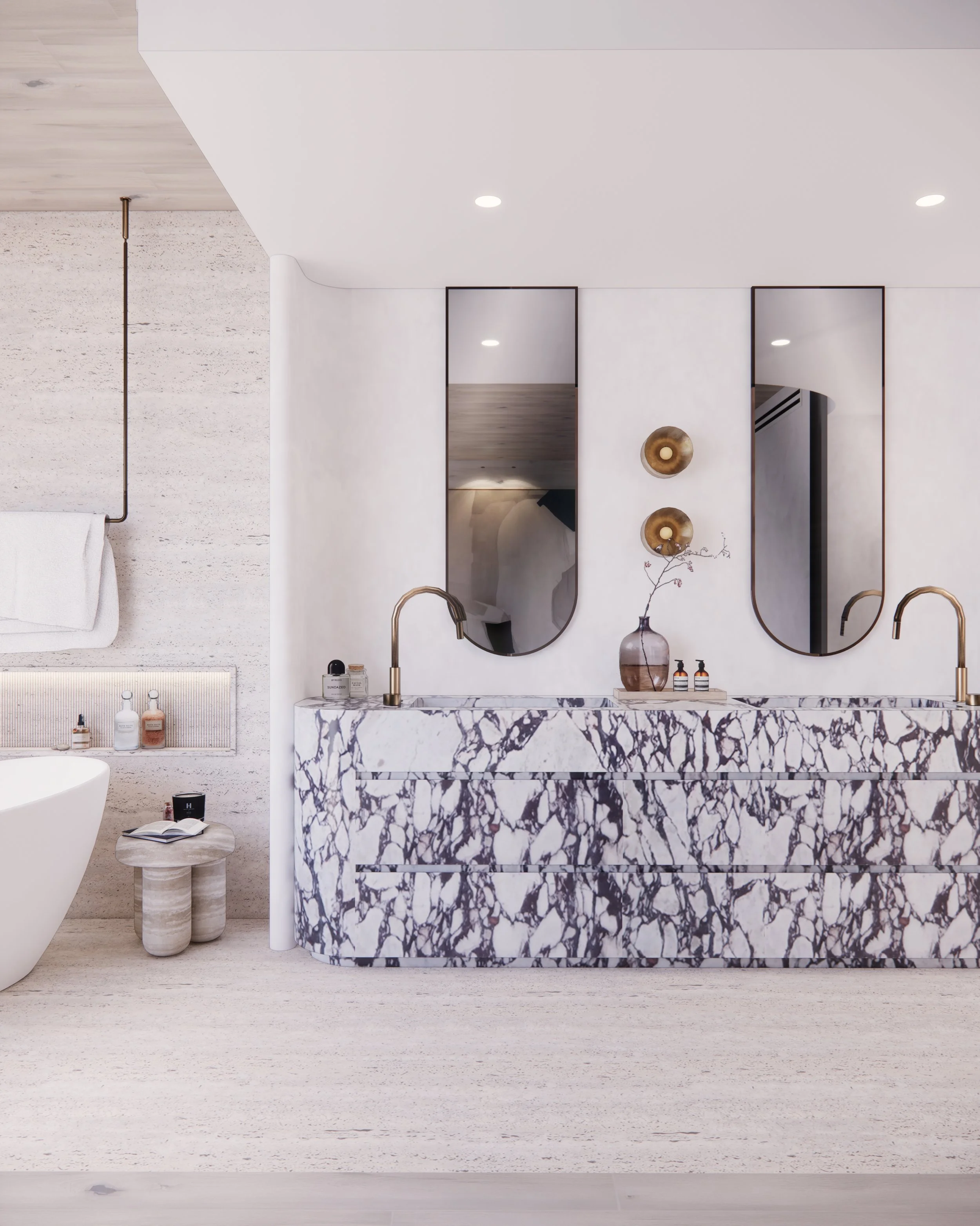 Sculptural double vanity in bold veined marble with curved detailing and brass tapware