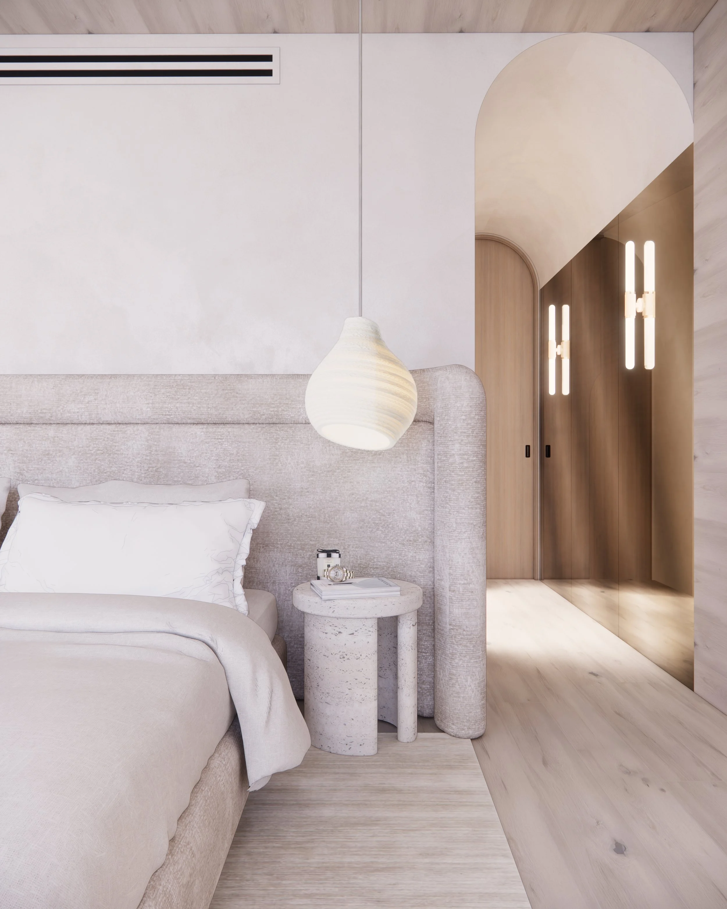 Neutral primary bedroom with textured upholstered bed, sculptural stone side table, and organic lighting