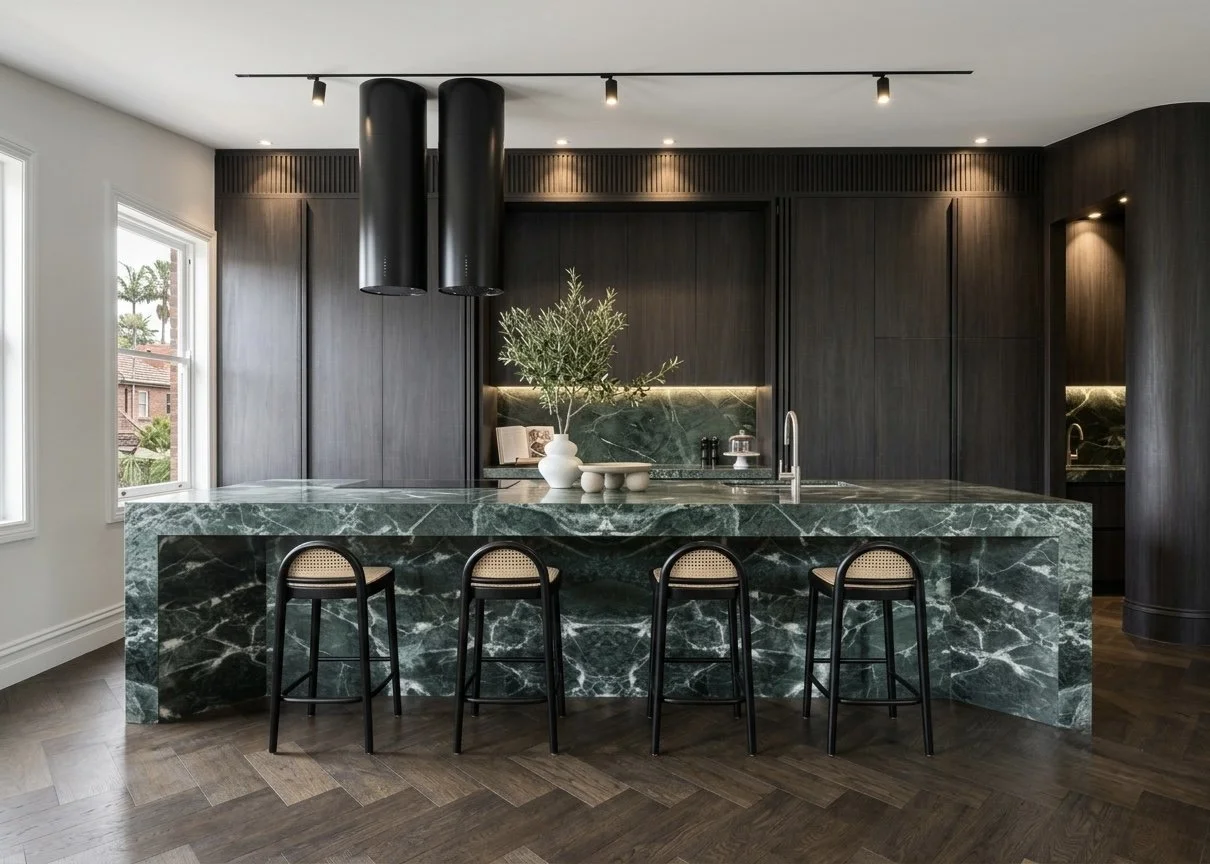 Contemporary kitchen with dramatic green marble island and dark joinery in renovated Sydney terrace