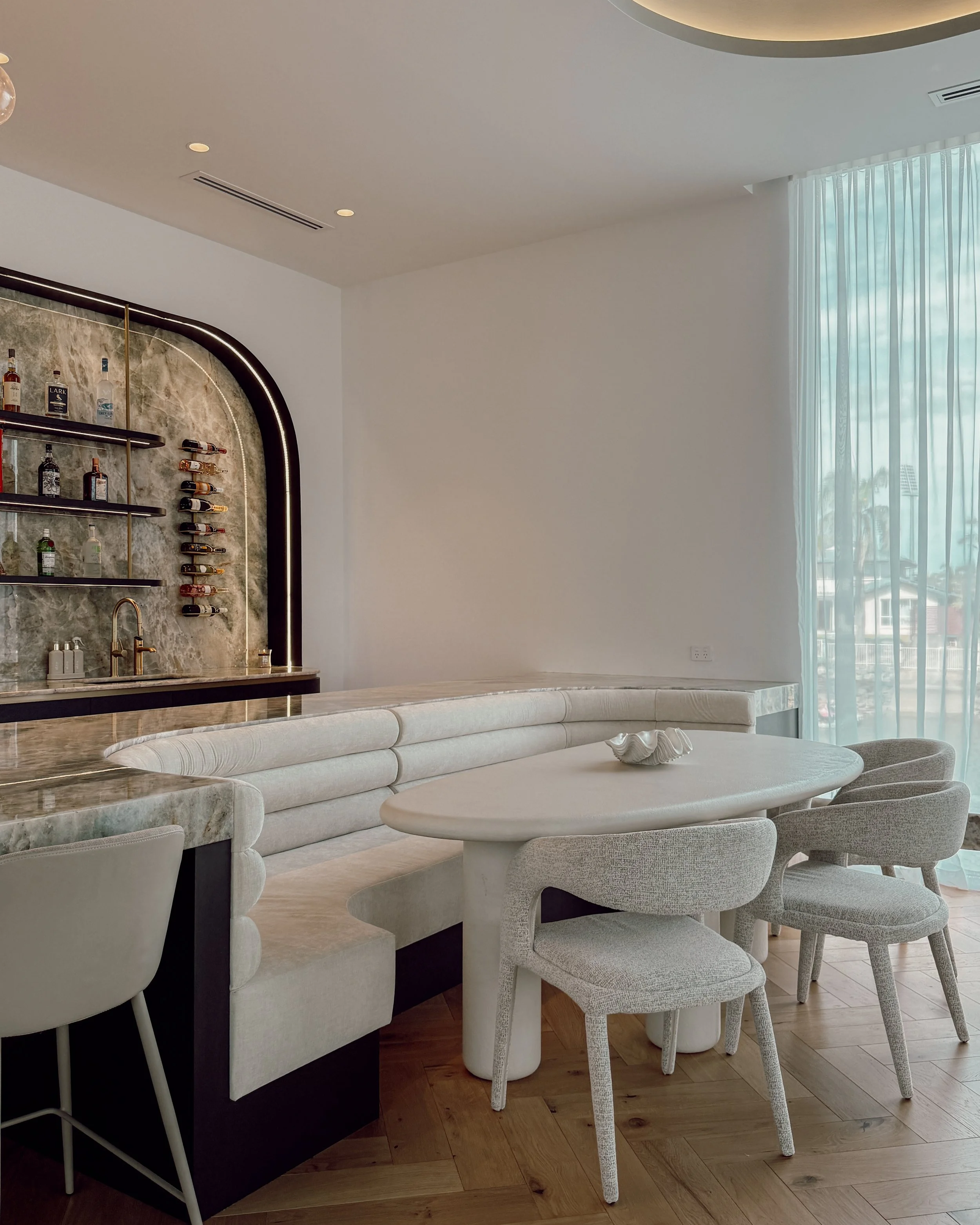 Modern coastal bar with island booth seating in a pool house in Brisbane, designed by TID Studio Sydney