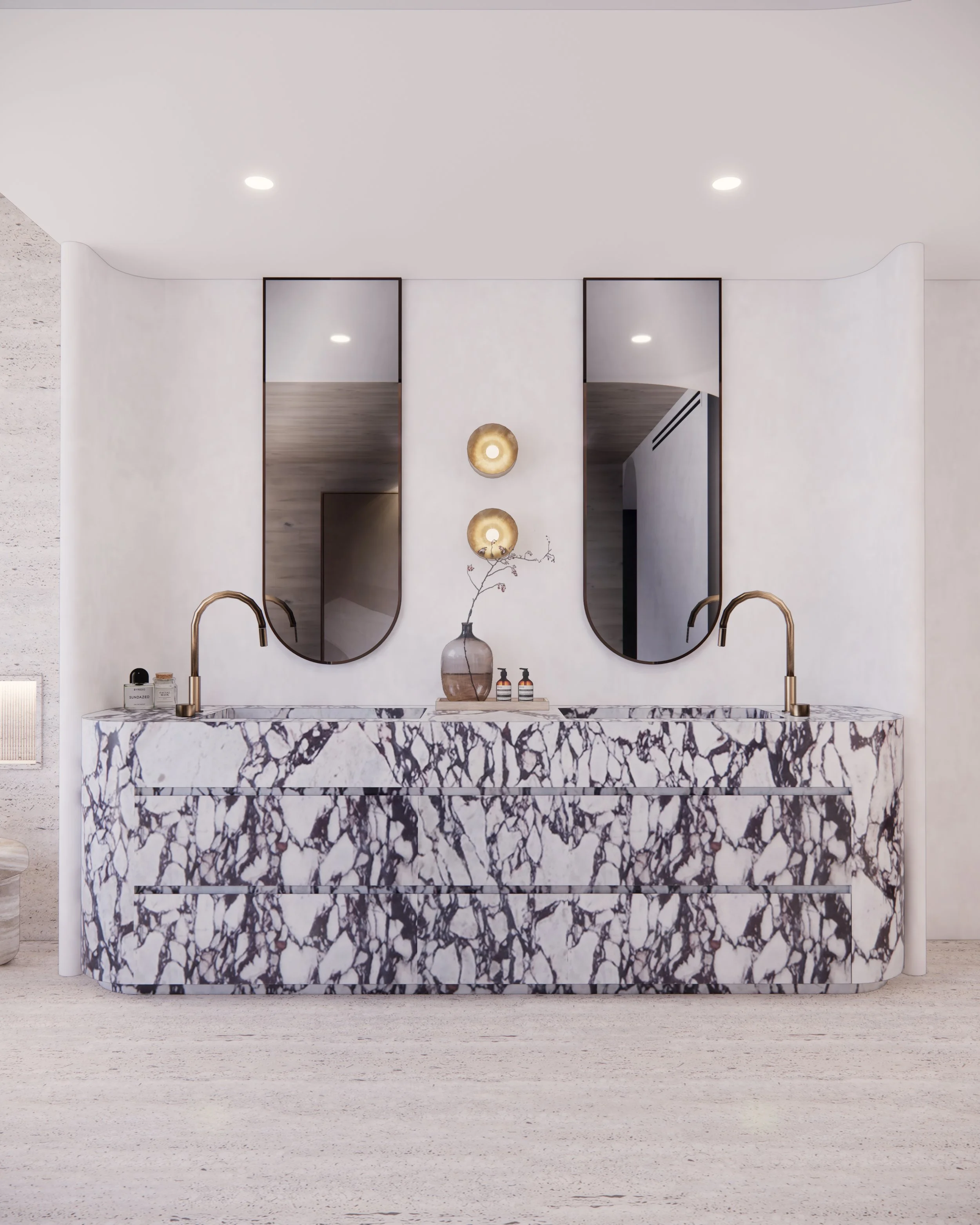 Sculptural double vanity in bold veined marble with curved detailing and brass tapware