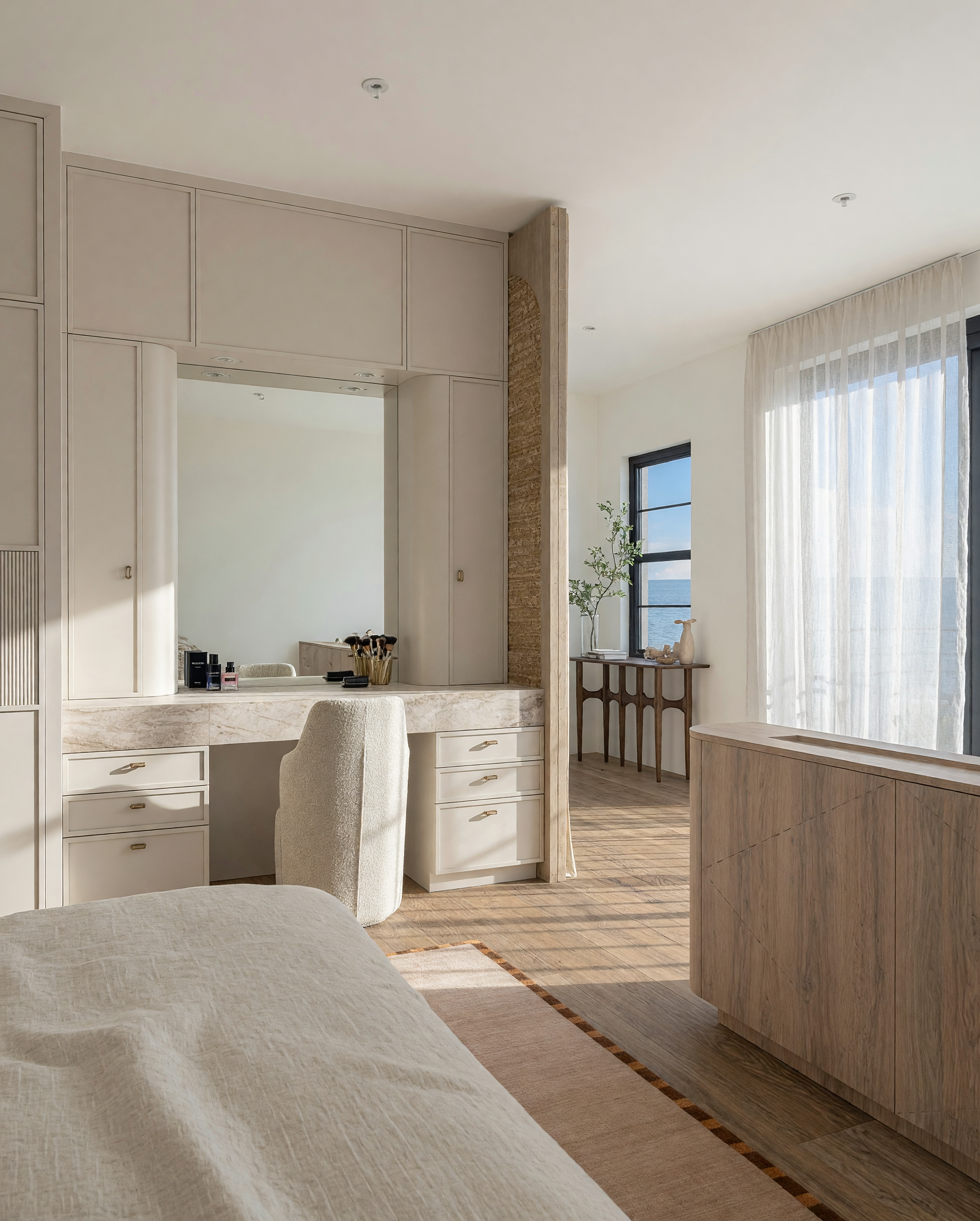Modern primary bedroom, custom headboard with fluted bedside console drawers, make-up desk, condo remodel in Miami, designed by TID Studio 