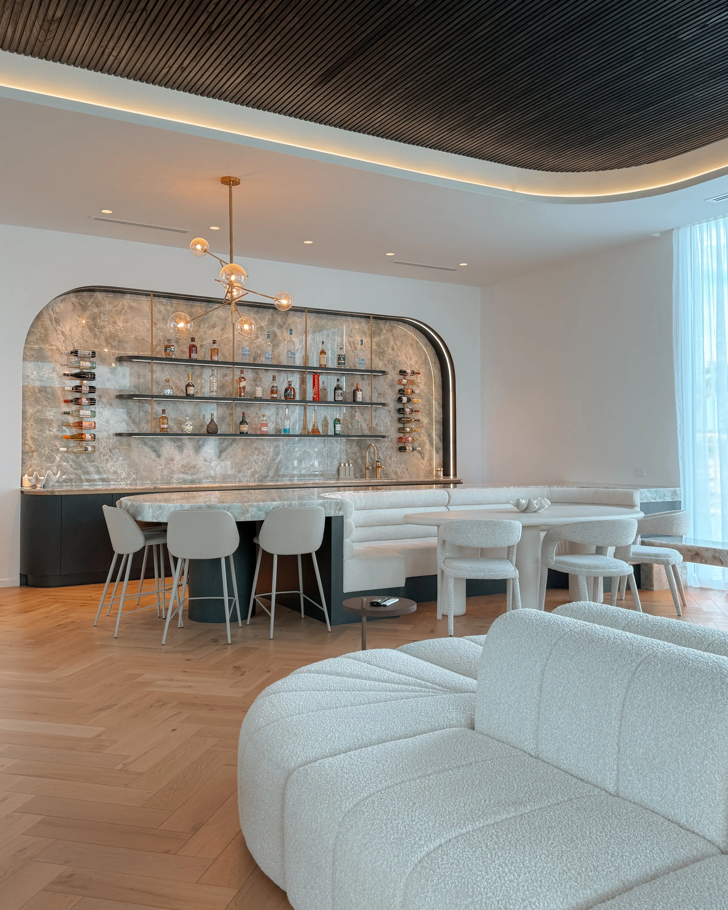 Modern coastal bar with island booth seating in a pool house in Brisbane, designed by TID Studio Sydney