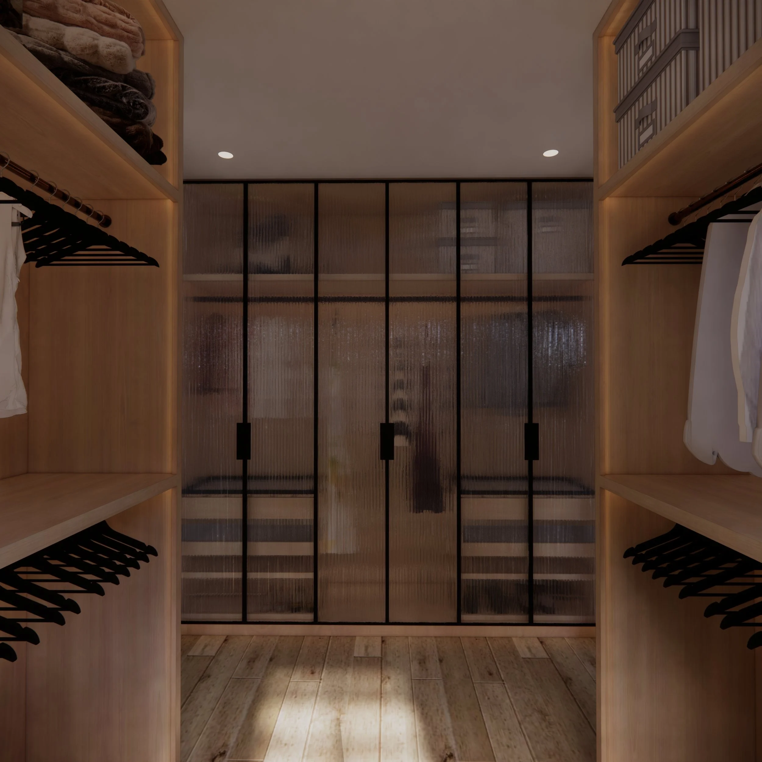 Custom walk-in robe with fluted glass wardrobes, integrated lighting and bespoke storage designed by TID Studio
