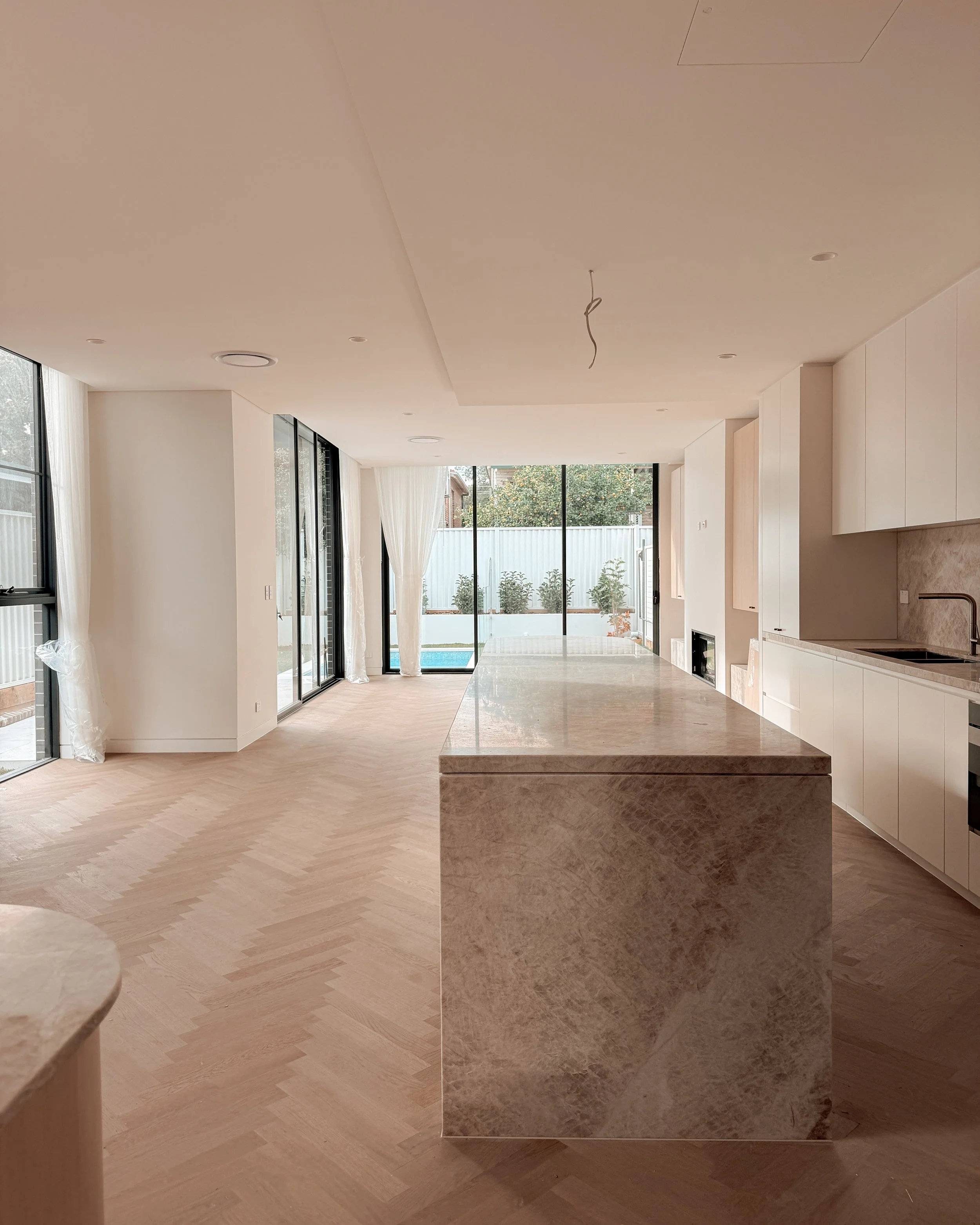 TID Studio. Contemporary kitchen design, taj mahal island, pantry, dining, bar, neutral creamy colour palette. Interior design Sydney. New build Five Dock