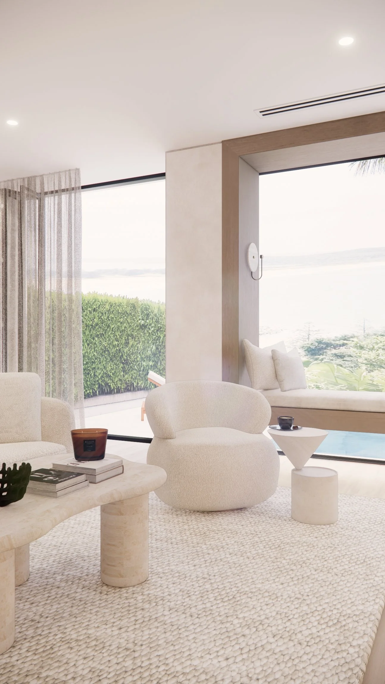 Contemporary coastal living room with curved fireplace, neutral textures, and large window seat overlooking the water — Sydney interior design by TID Studio