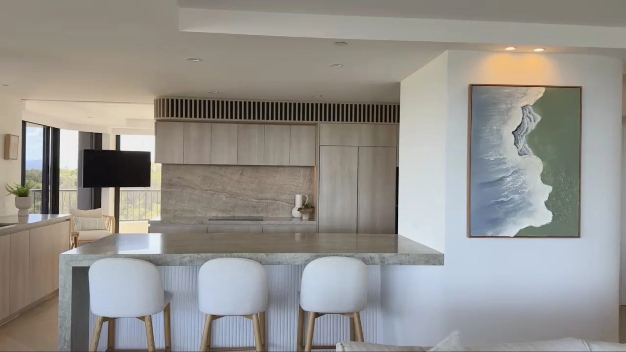 Soft neutral kitchen with ocean views and minimalist joinery by TID Studio