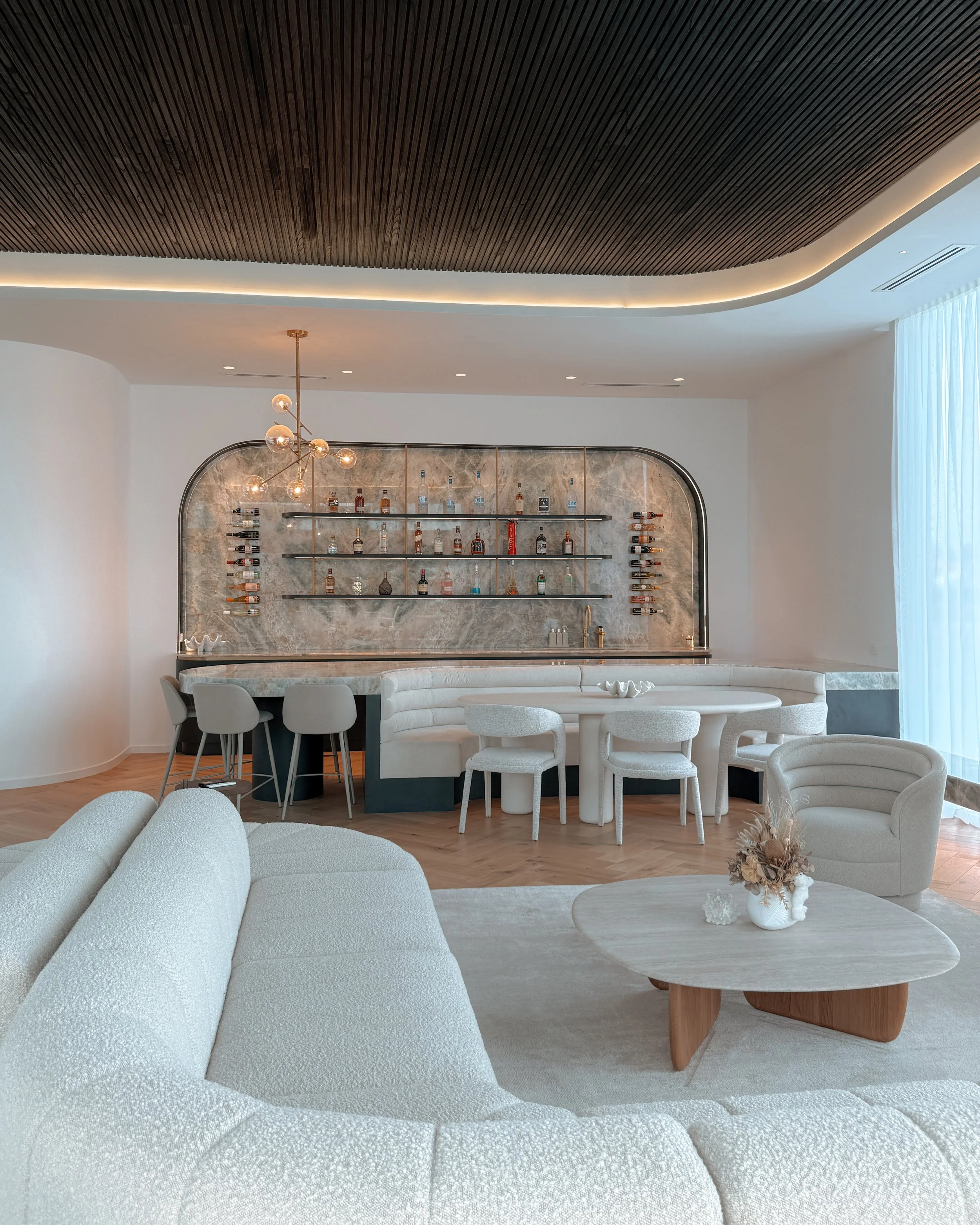 Modern coastal bar with island booth seating in a pool house in Brisbane, designed by TID Studio Sydney