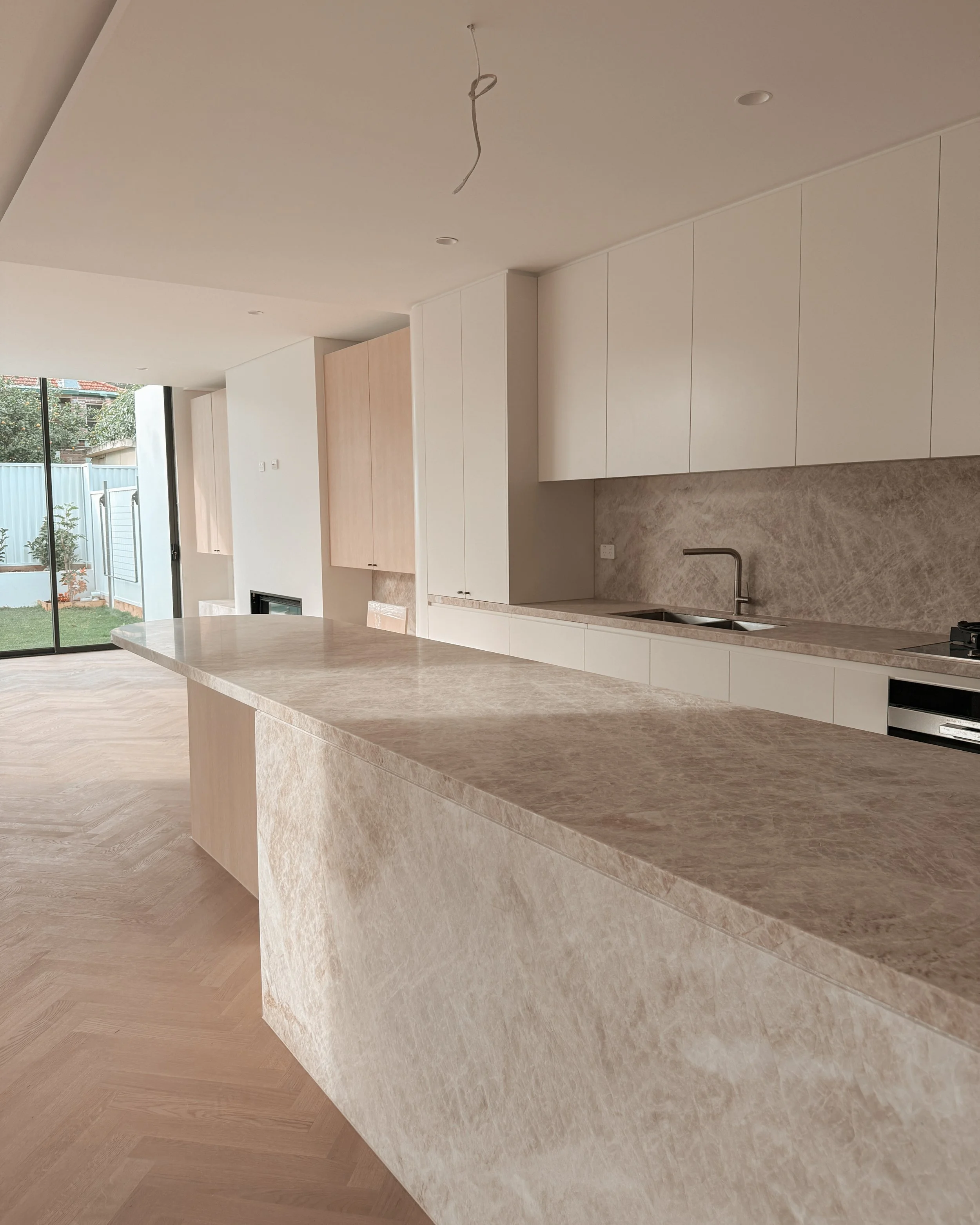 TID Studio. Contemporary kitchen design, taj mahal island, pantry, dining, bar, neutral creamy colour palette. Interior design Sydney. New build Five Dock