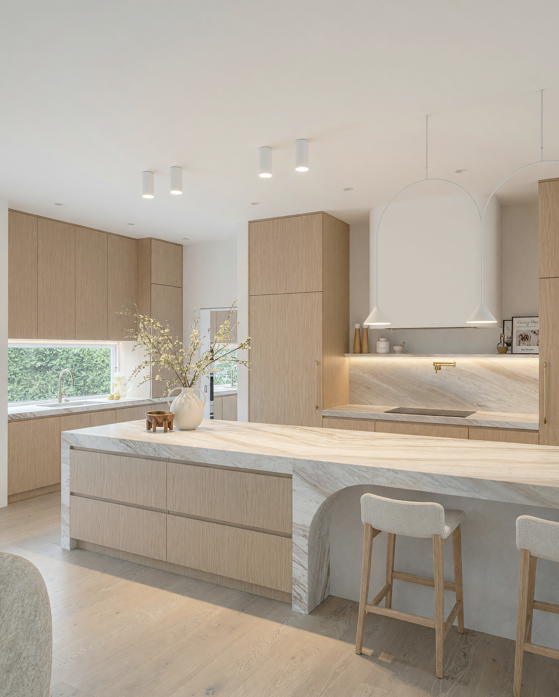 Contemporary kitchen with Taj Mahal quartzite island, bronze custom rangehood and integrated oak cabinetry